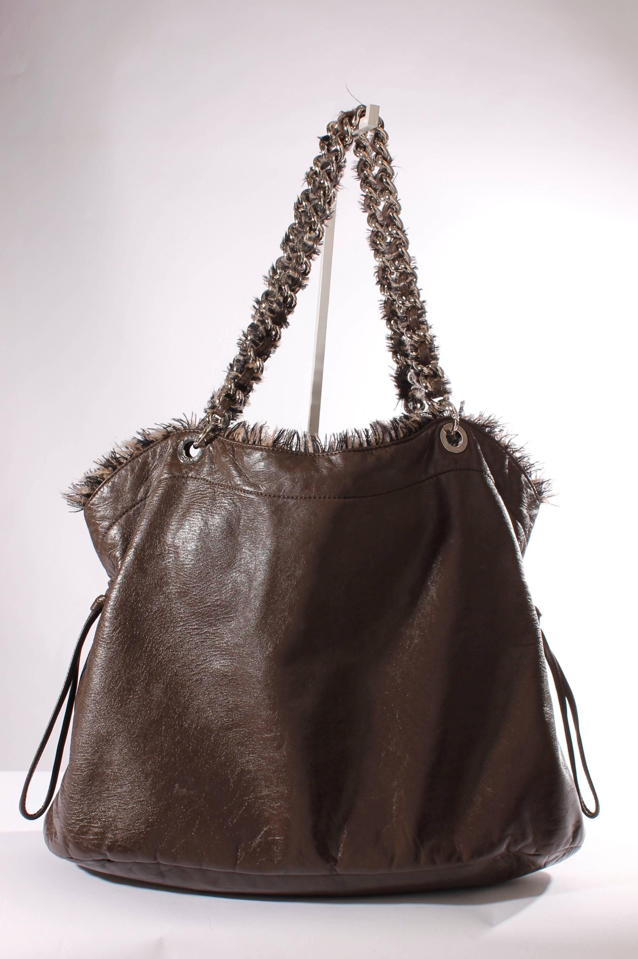 Soft and supple shopper by Chanel, this bag has a sturdy look!

This Chanel Shopper Ruffle Tote Bag is made of brown leather with ruffles in black and brown wool. Nice size; 42 centimeters wide and 31 centimeters high. Silver hardware.

The