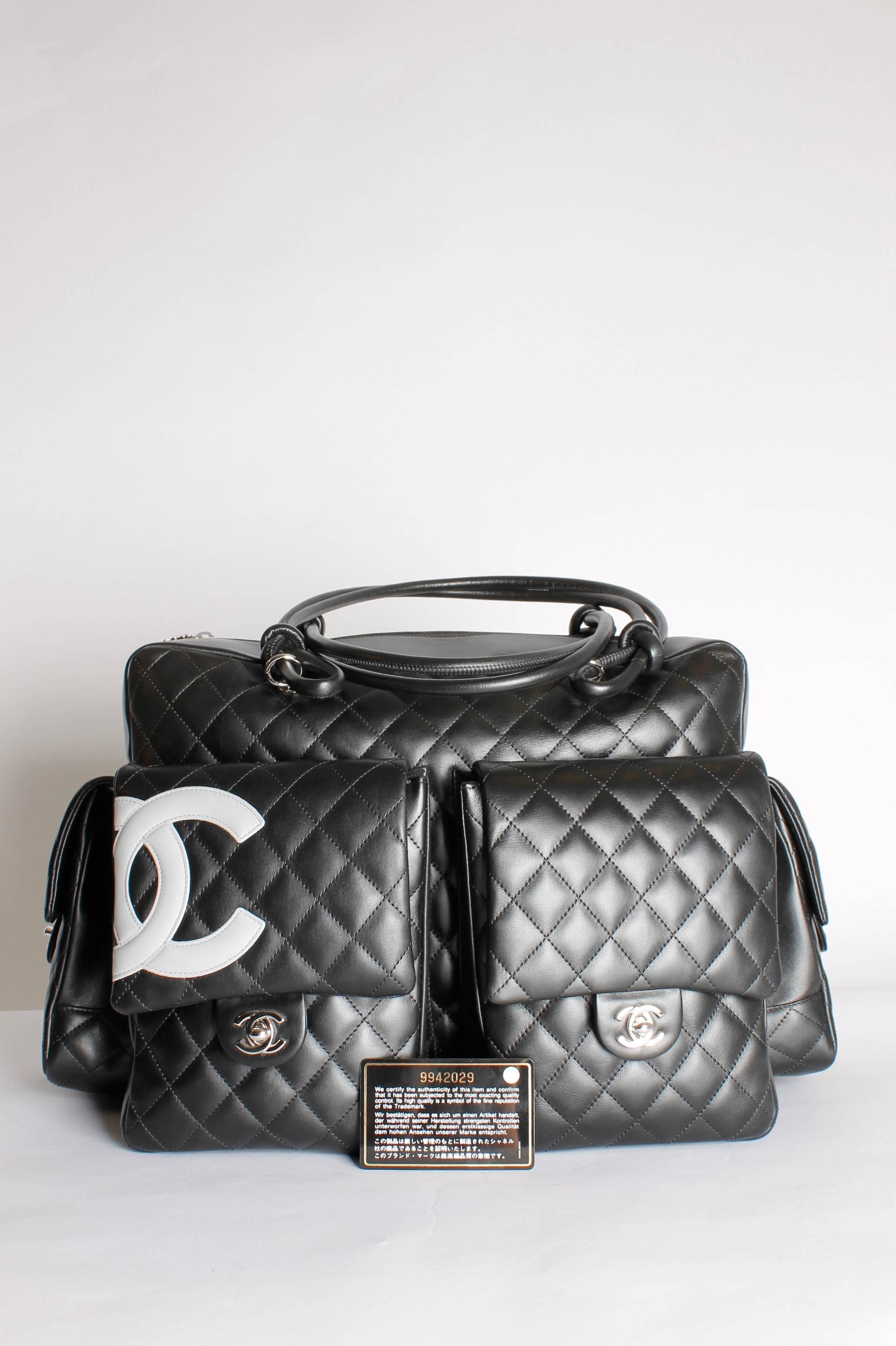 This one is big, really big! It's the Chanel Ligne Cambon Multipocket Reporter XL Bag and it's used as a weekend-bag.

Four large pockets at exterior, they all have a flap and a silver turn-lock closure. On one of the pockets a grey interlocking
