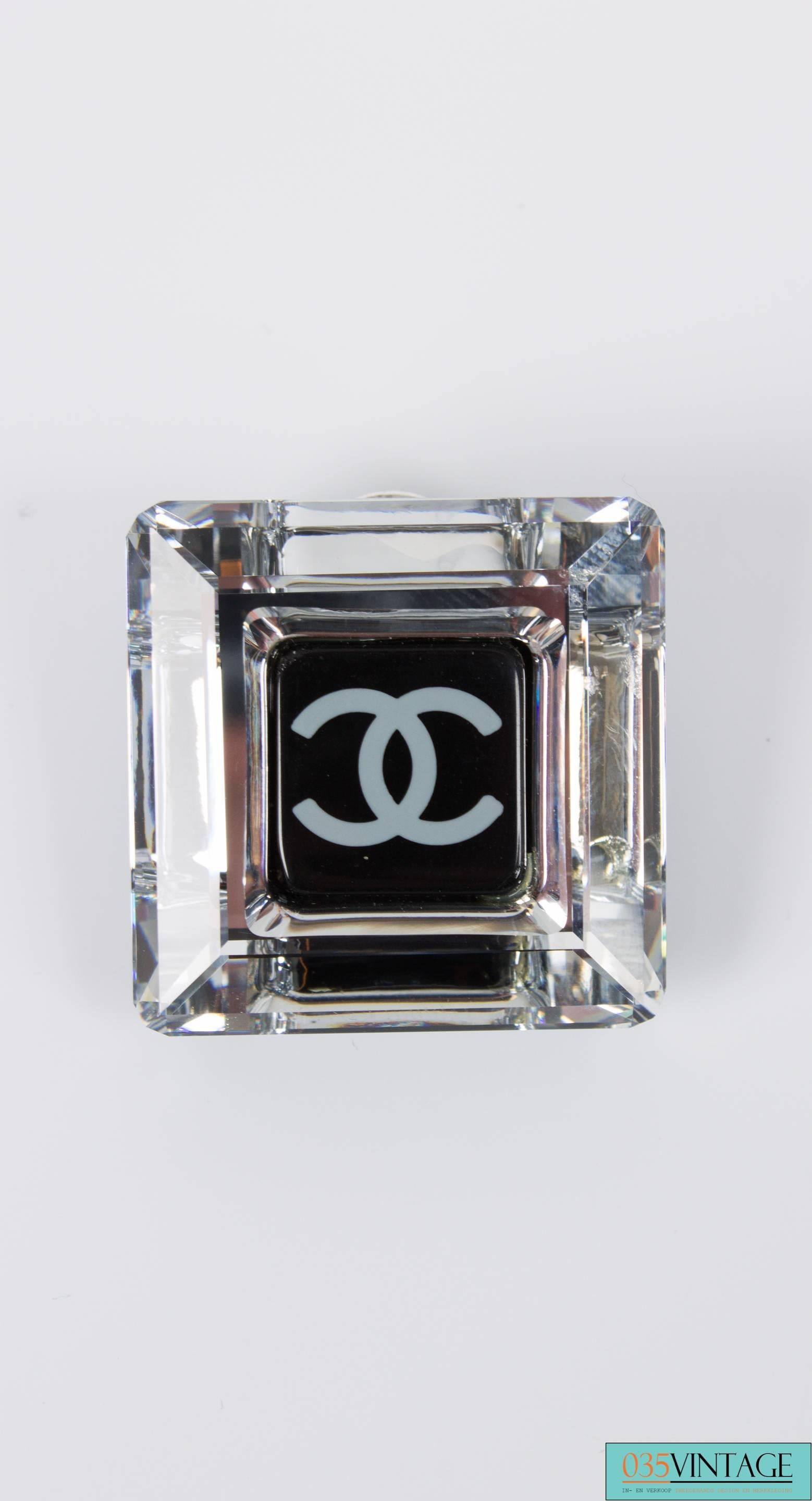 This jewelry set in black and white is chic and timeless, Chanel calls this Black & White Crystal Cube. It's from the 2006 Cruise Collection.

The crystal cube ornament (2x2 cm) has a white interlocking CC logo in the center and hangs down from a