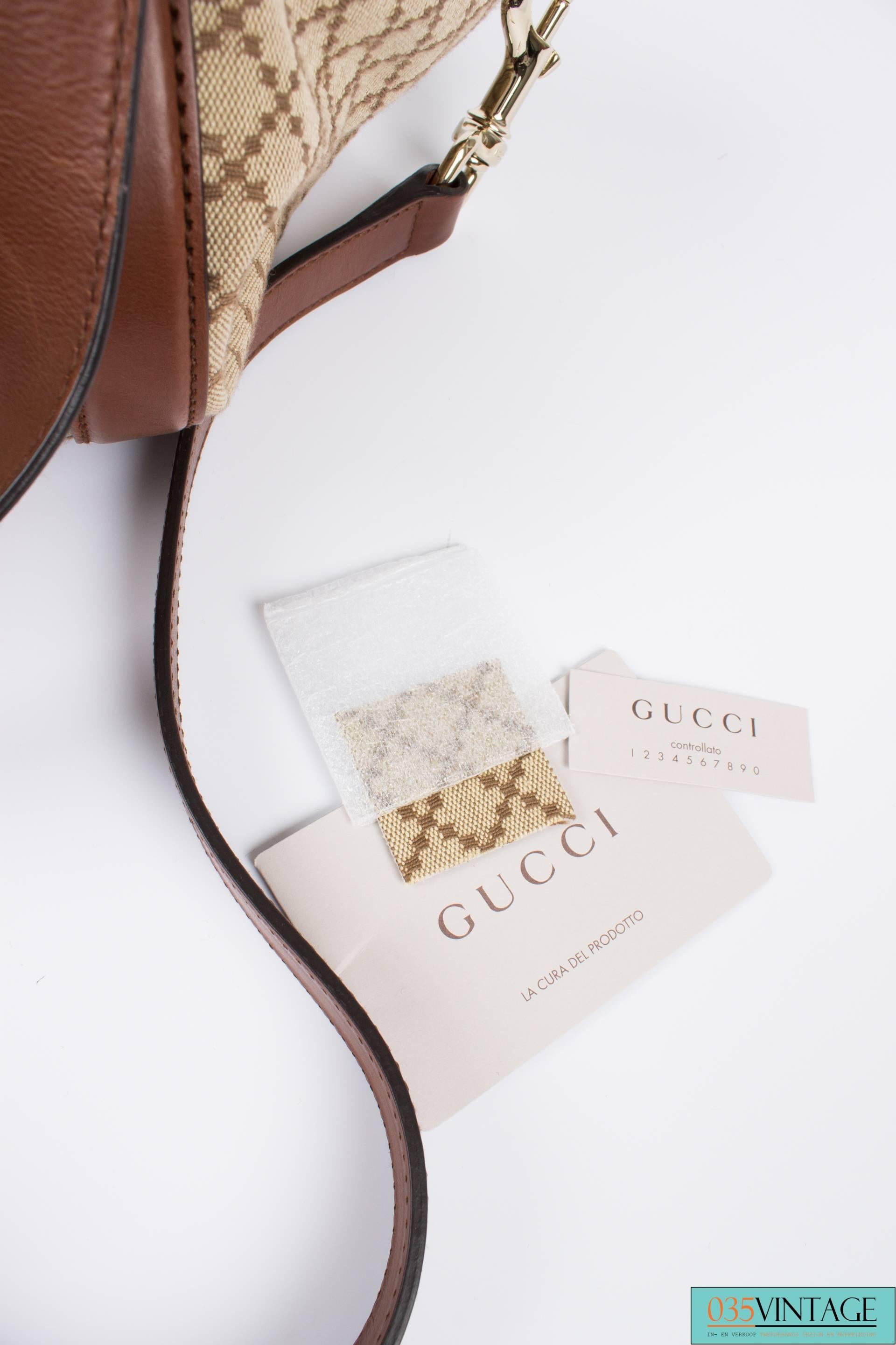 A classic one by Gucci: this is the Diamante Canvas Village Double G Tote! And it's beautiful!

Made of stirdy beige canvas with a woven diamond pattern, brown leather trimming and very light gold-toned hardware. The interior is fully lined with