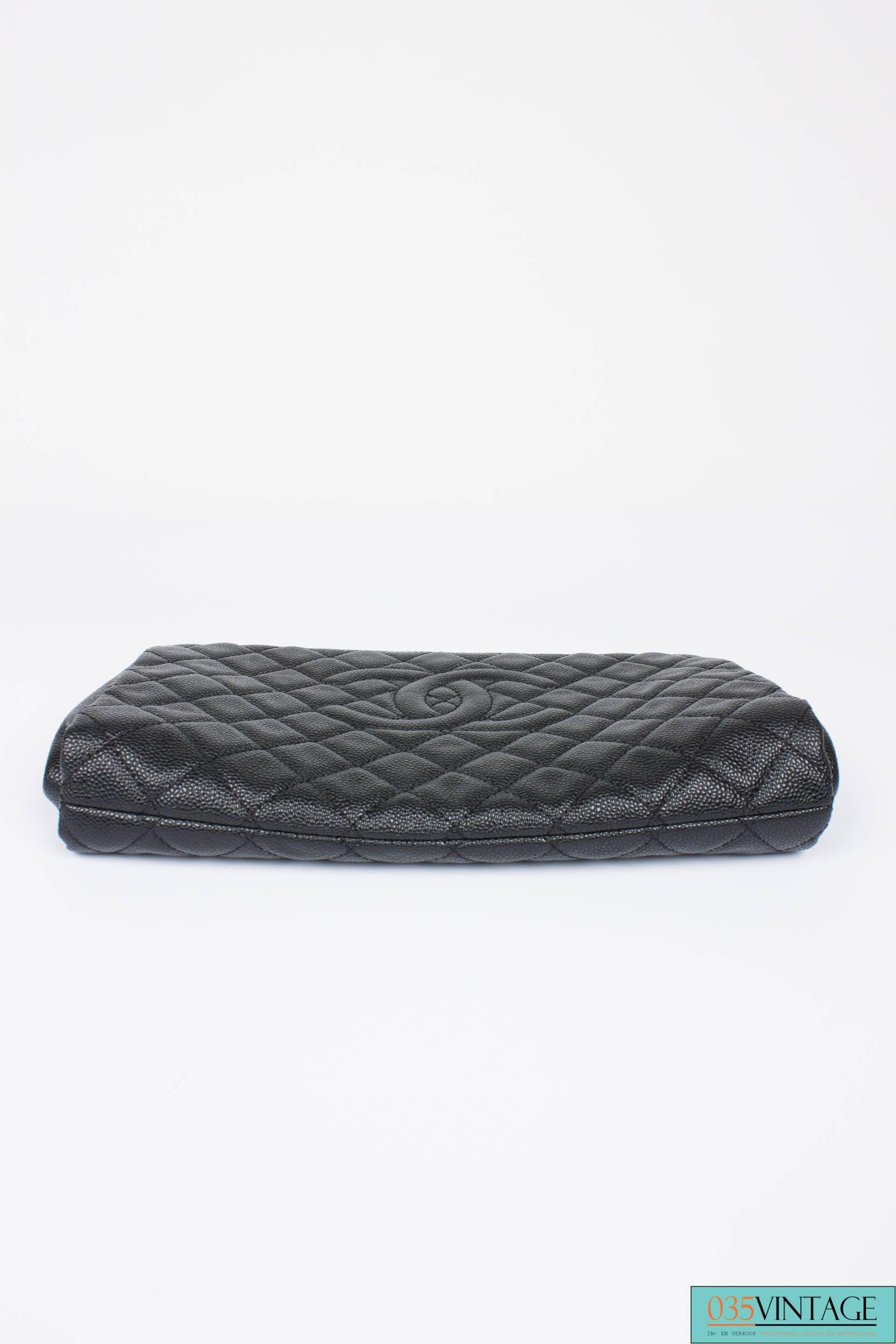 Sturdy and wonderfull clutch by Chanel; it is the Quilted Caviar Jumbo CC Clutch Bag.

The caviar leather is firm, but yet soft and fully quilted. A very large embroidered CC logo on the front. At the top the frame opens with two magnetic snaps.