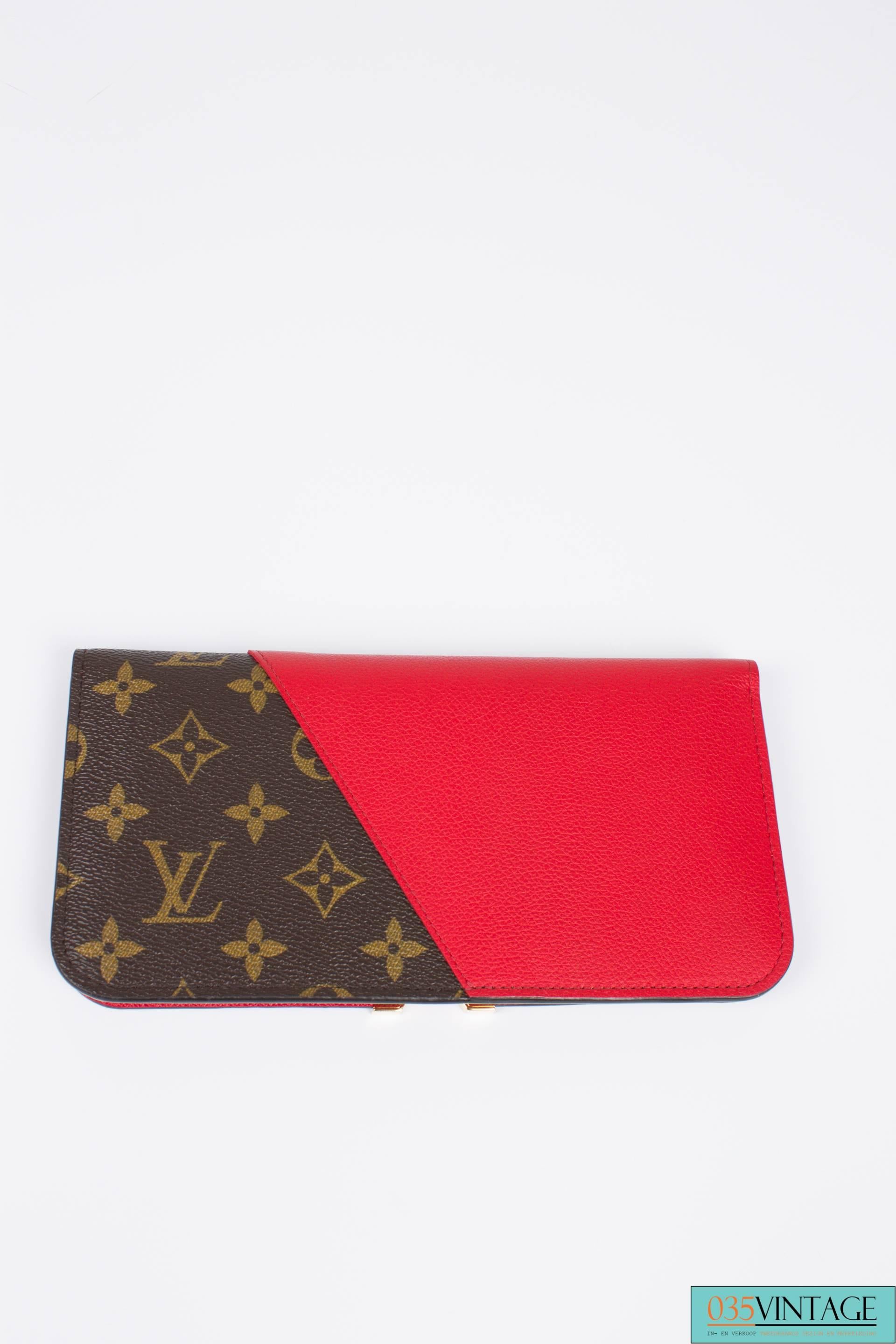 This is the Louis Vuitton Kimono Wallet, and it's marvellous!

The iconic brown LV monogram canvas is combined with red calfskin leather. A large golden metal V in the center. Closure with two little push button.

On the inside this wallet is