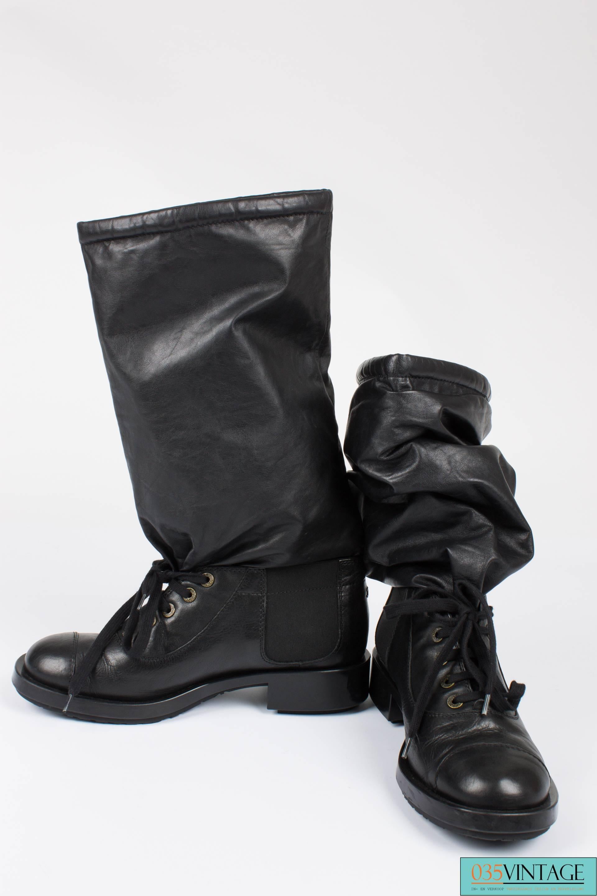 Slouchy combat boots by Chanel, seen on the Runway of 2011. How cool are these?!

A sturdy sole with a high gloss finish on the sides. Laces at the front and a piece of elastic on both sides of the ankle. A round reinforced toe. The heel measures