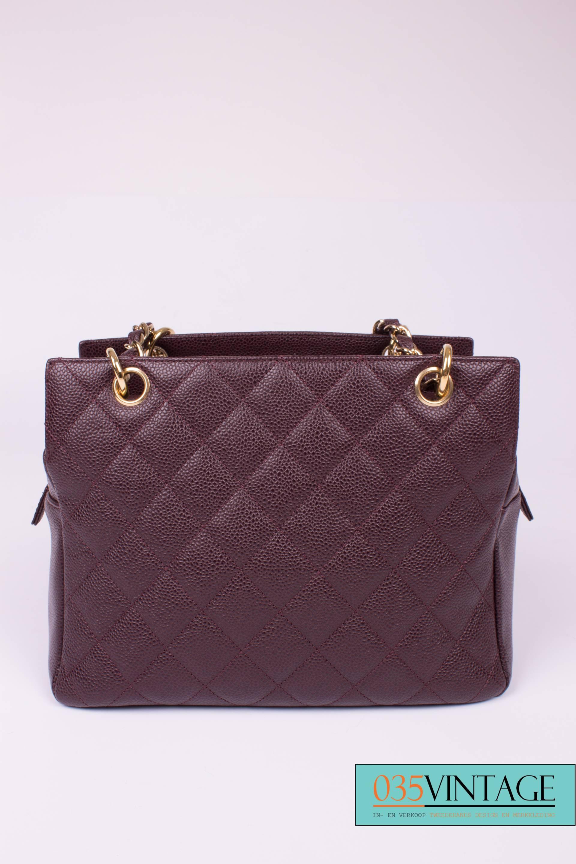 A gorgeous burgundy coloured caviar leather Chanel bag from 2003! This is the 'Quilted Caviar Leather PTT Petite Timeless Tote Bag'. It is in excellent overall condition and has no signs of wear. In fact, this bag is brand new! The blotting paper is