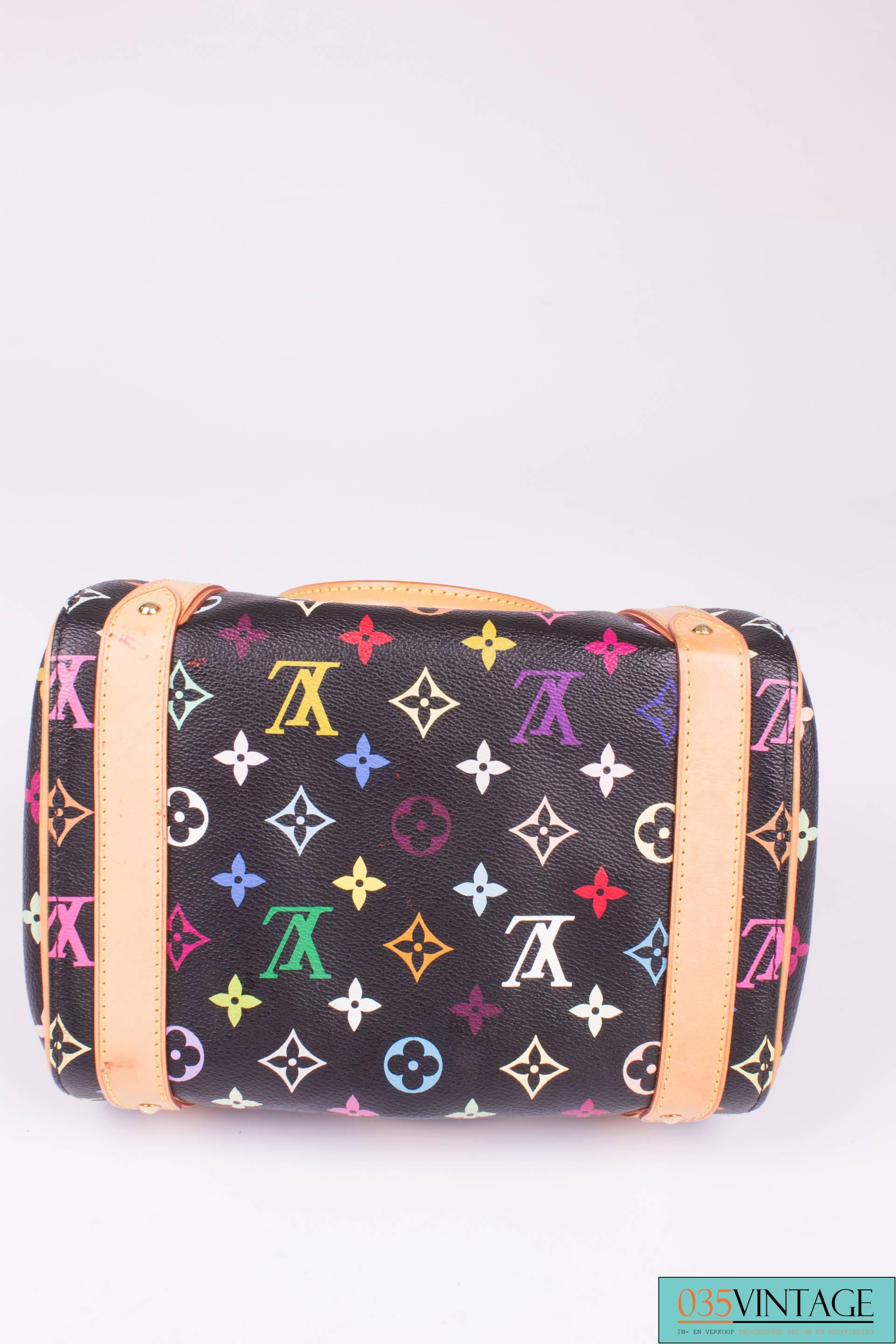 This bag is adorable and playful; it is the Louis Vuitton Monogram Multicolor Priscilla Bag, this time in black.

Uniquely shaped, this style is based on the bowling bag with a little flap pocket on the front. The black canvas is covered with