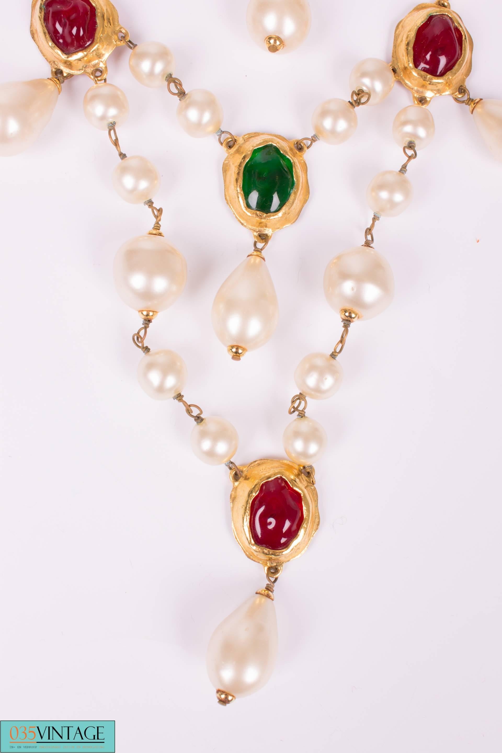 A vintage 80's necklace by Chanel, you can't deny this much beauty!

The necklace has three layers and is mainly crafted of faux pearls in different shapes and sizes. Some gripoix beads with a golden brim have been added in red, green and blue.