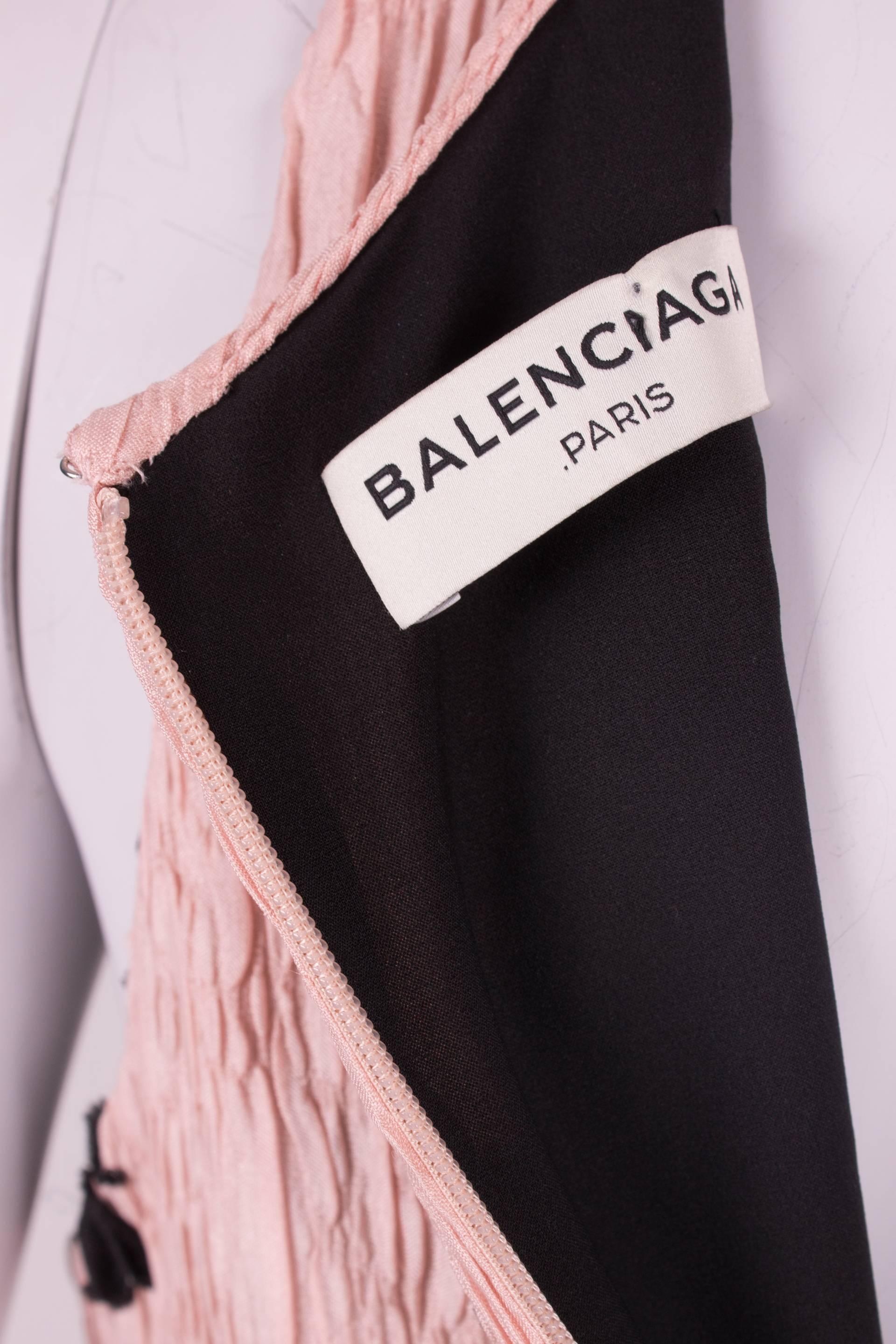 A perfect and body-contouring dress by Balenciaga Paris covered with black flower appliques. Picture perfect!

This sleeveless dress has a scoop neckline and concealed zip closure on the back. Crafted in a very pale pink and crinkled silk