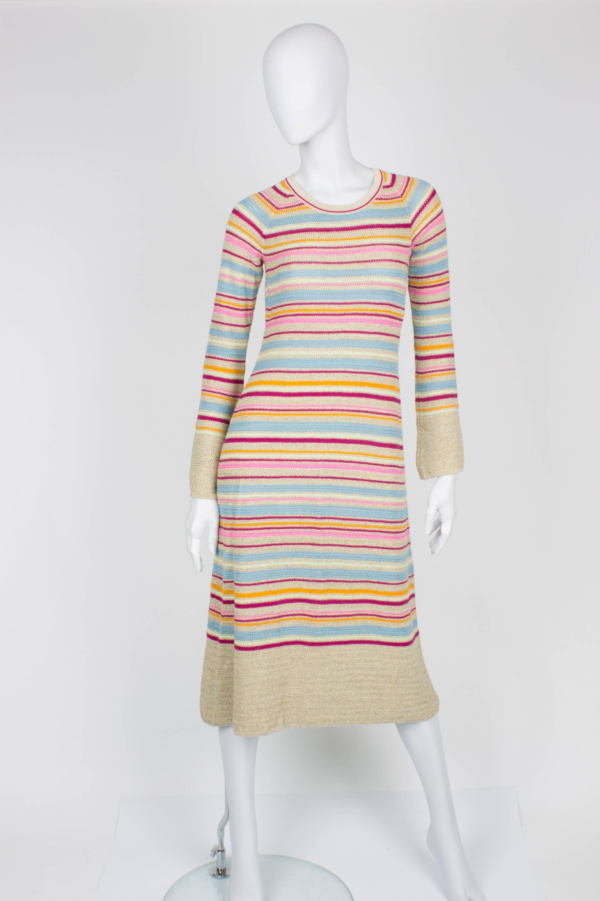 

Over-knee dress by Chanel from the Resort Collection of 2011. We love the candy colors!

Long sleeved knit dress in multi-color: light blue, pink, orange and fuchsia. Some golden thread is added for extra glamour. No lining. Closure in the back of