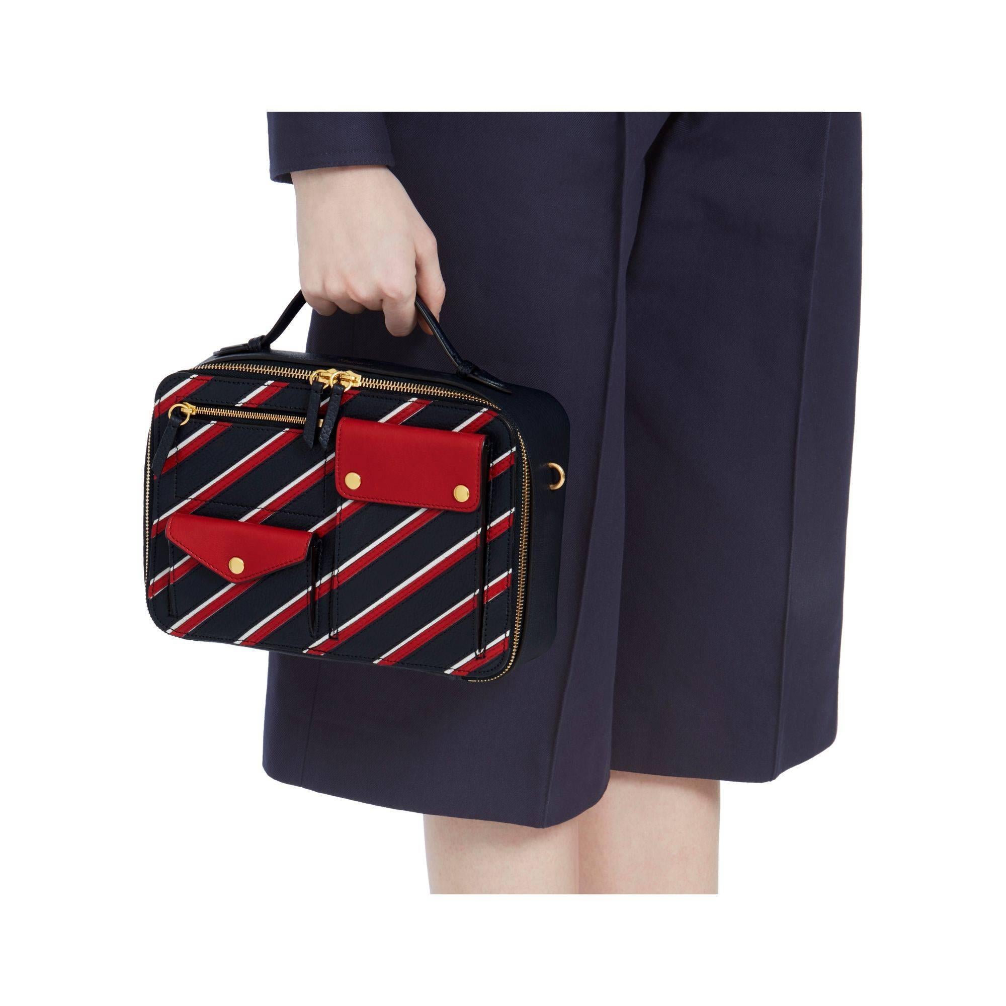 From the Mulberry Spring/Summer 2017 Runway Collection: this is the Cherwell Square Shoulder Bag.

This bag has a 'vintage feel' and is crafted in dark blue, red and white leather. Gold tone hardware, zippers and push buttons. A top handle and