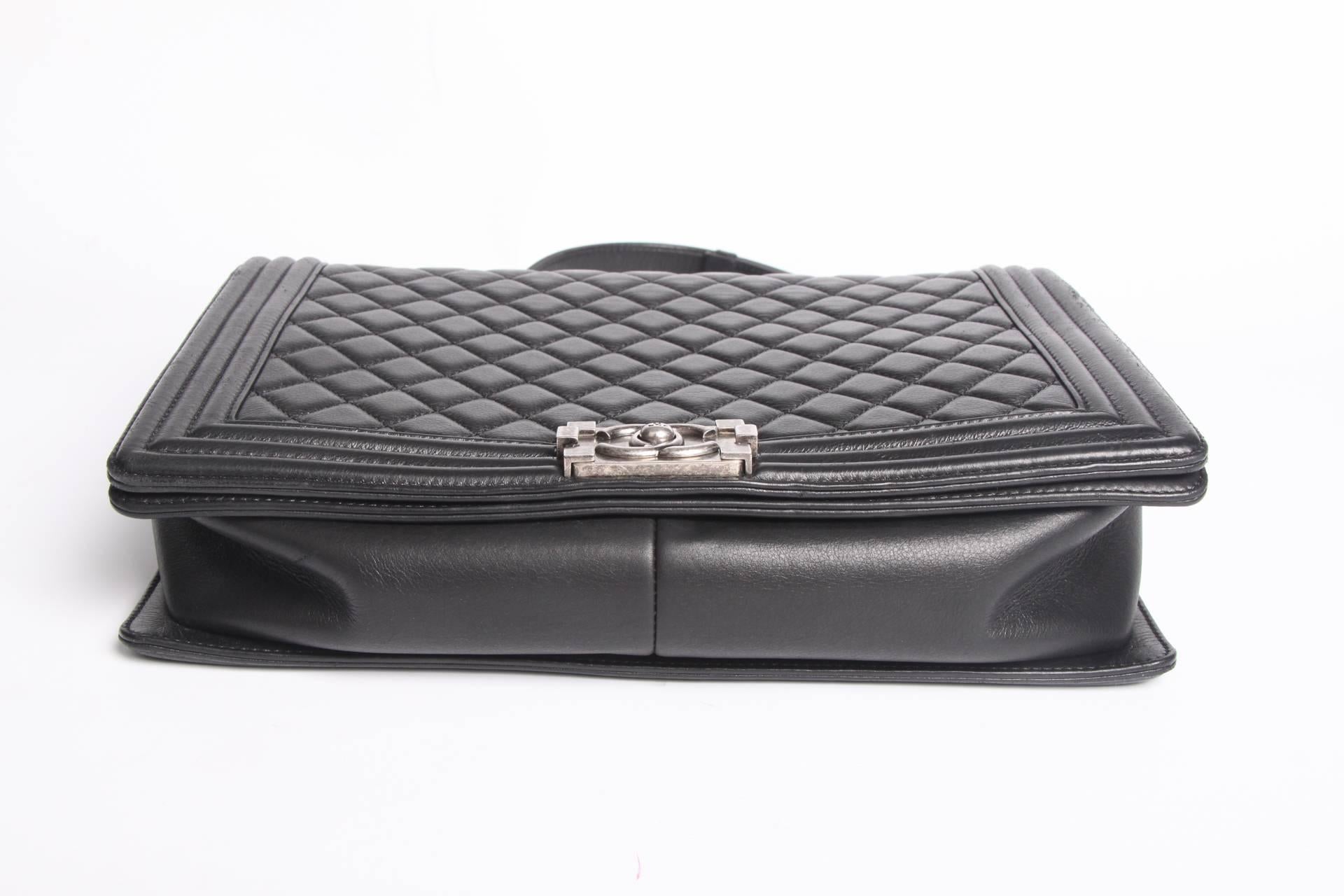 The iconic CHANEL Boy Bag with a modern look, this one is crafted in black leather.

This black bag has size L and is from 2014, in 2011 Karl Lagerfeld introduced the signature lock of this bag. An unique lock, you have to push it on both sides to