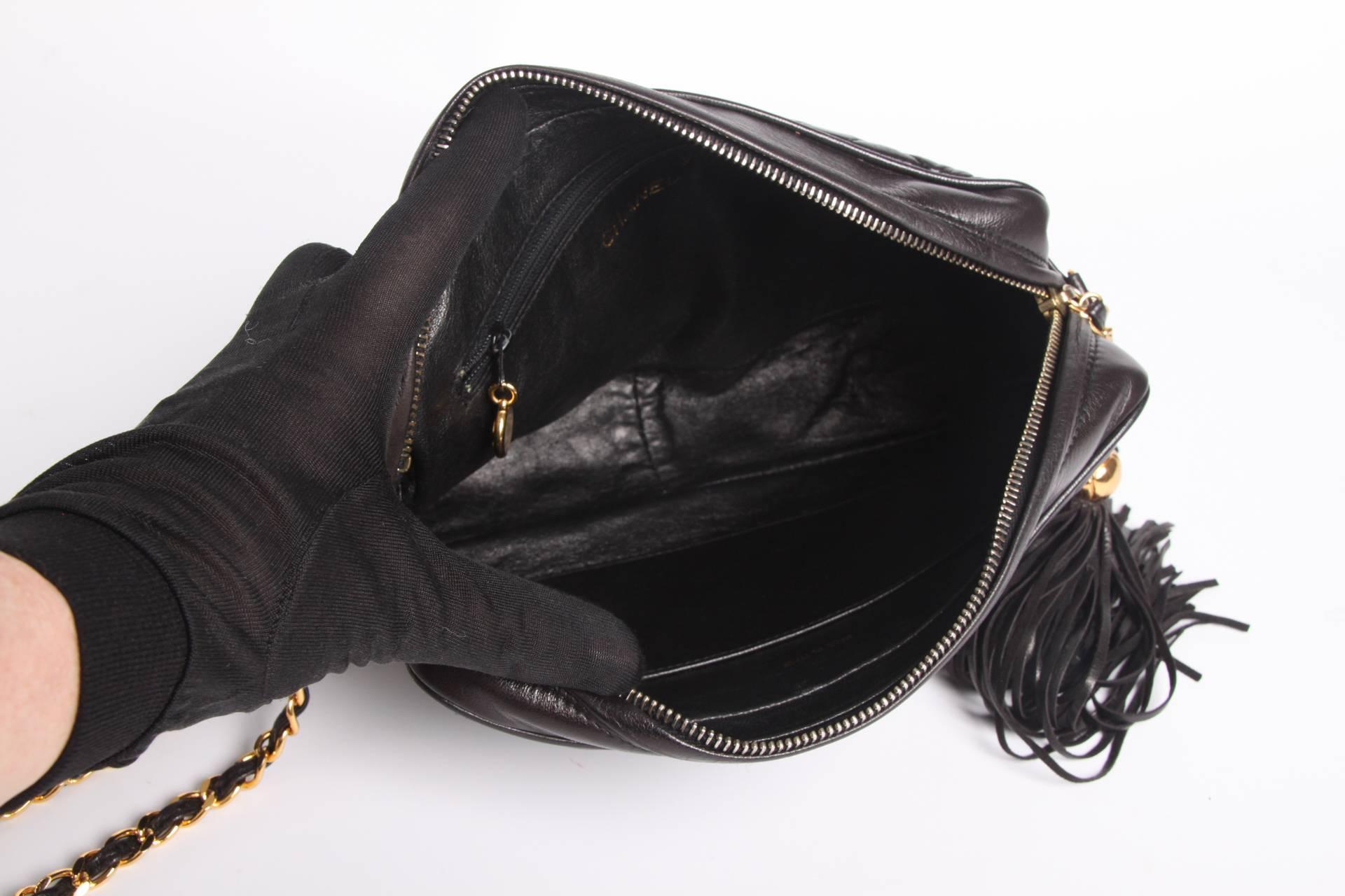 Yes!! A vintage Camera Bag by Chanel from 1995 in supple black qulted leather.

This bag has a very handy size and top zip closure. A large leather tassel with gold-tone detailing and CC logo's is hanging down from it. 

At the front of the bag a