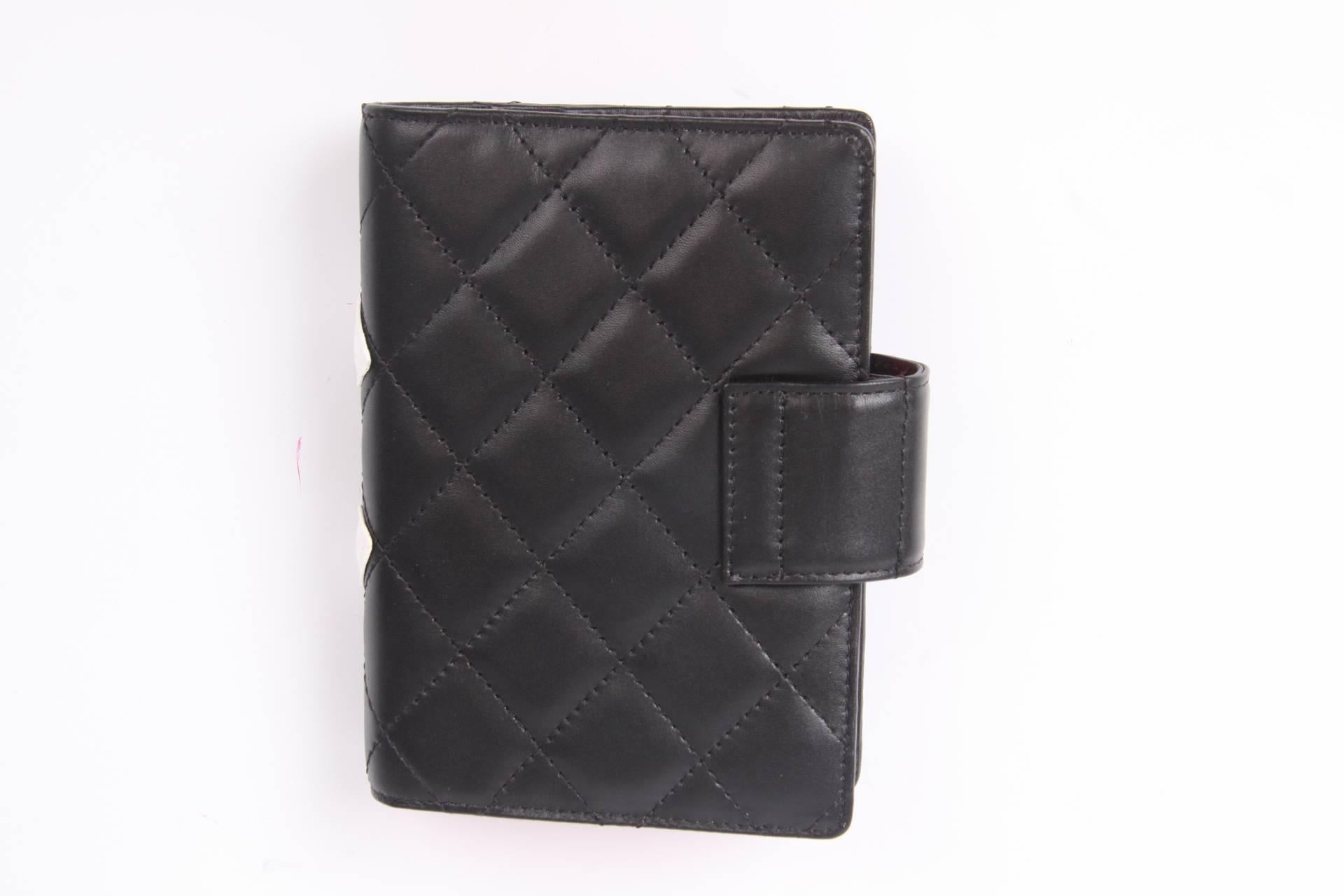 This one is brand new and fantastic! It is the Chanel Quilted Ligne Cambon Agenda Cover in black and white leather.

The black leather is fully quilted and has a large stitched CC logo in white. On the inside lining in bright pink covered with CC