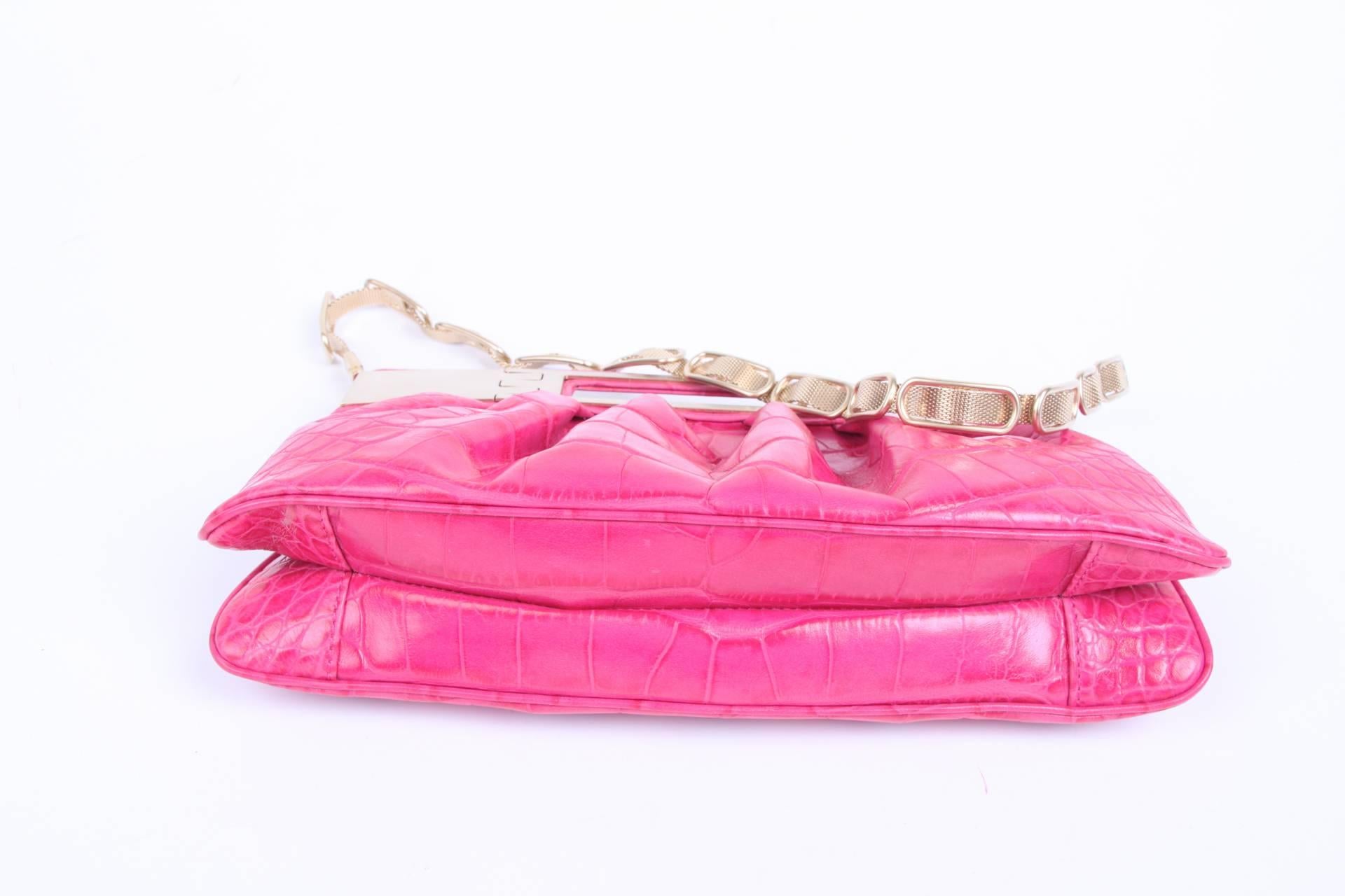 Shocking pink and yet very civilized Versace clutch from 2008 with matte golden detailing. Wonderful!

This clutch is made of leather embossed with a croco print. On top two handle and a golden braided chain. Magnetic snap button closure.

Lining on