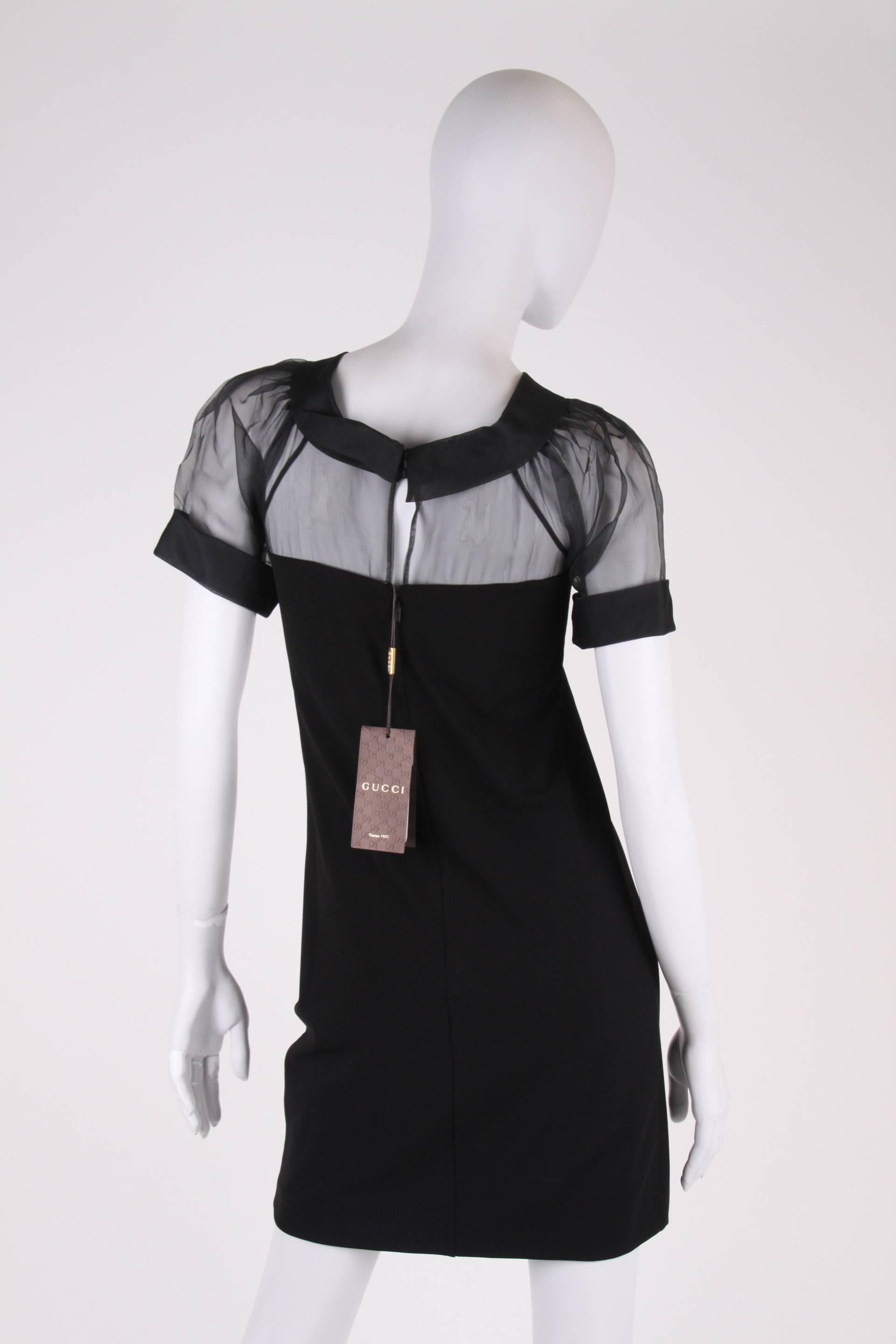 Stylish Gucci dress, the upper part is made of translucent black silk.

A round collar and short puffed sleeves, this dress has a zip closure on the back. The lower part is crafted in stretching fabric, for tailored fitting to the body. A little bit
