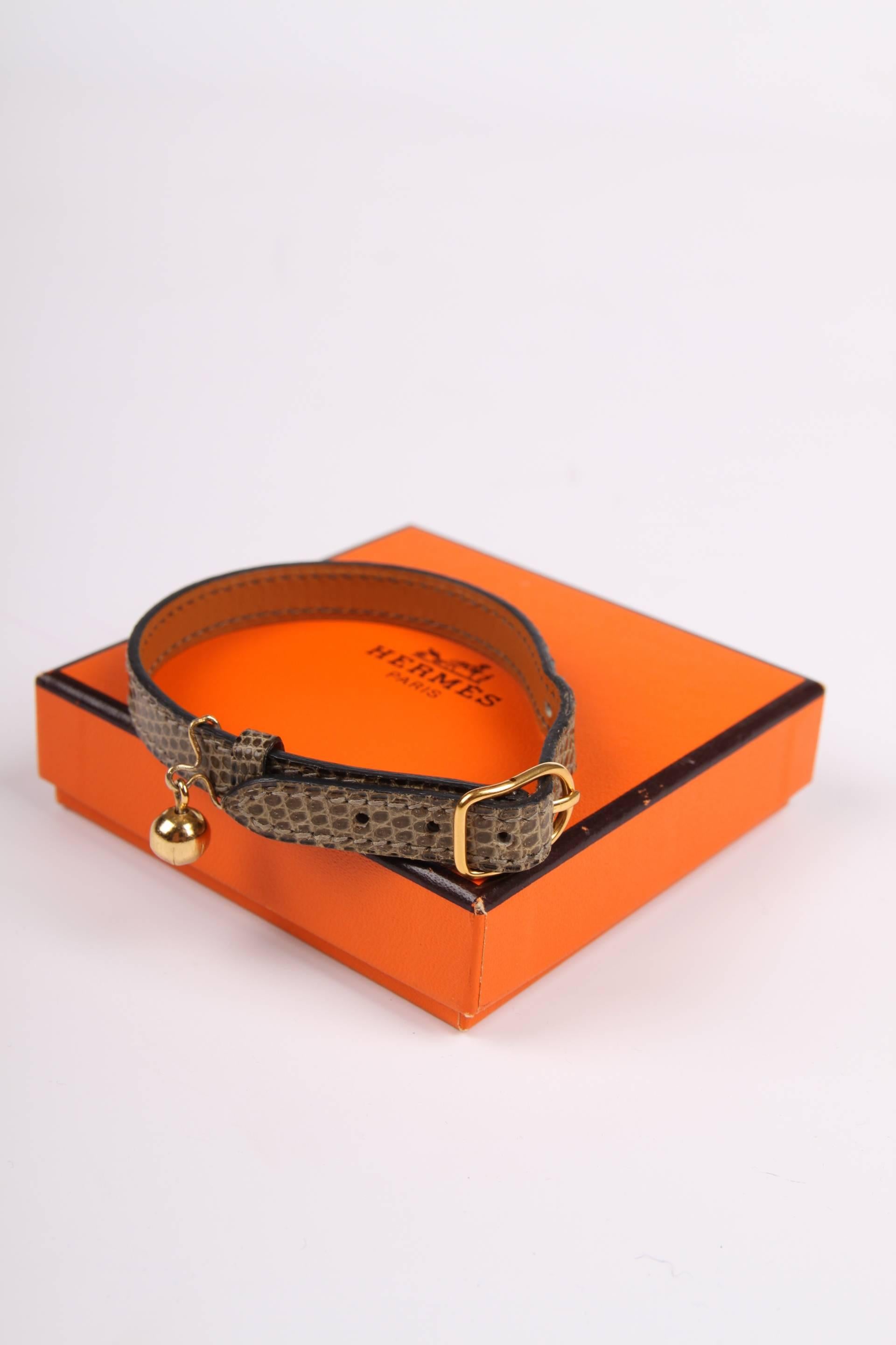 Who wants a fancy cat? A super cool Hermès collar for your furry and precious sweetheart!

Crafted in wonderful green lizard leather with a gold-tone buckle and a small round gold-tone bell. Total length of the strap is 25,5 centimeters.

In perfect