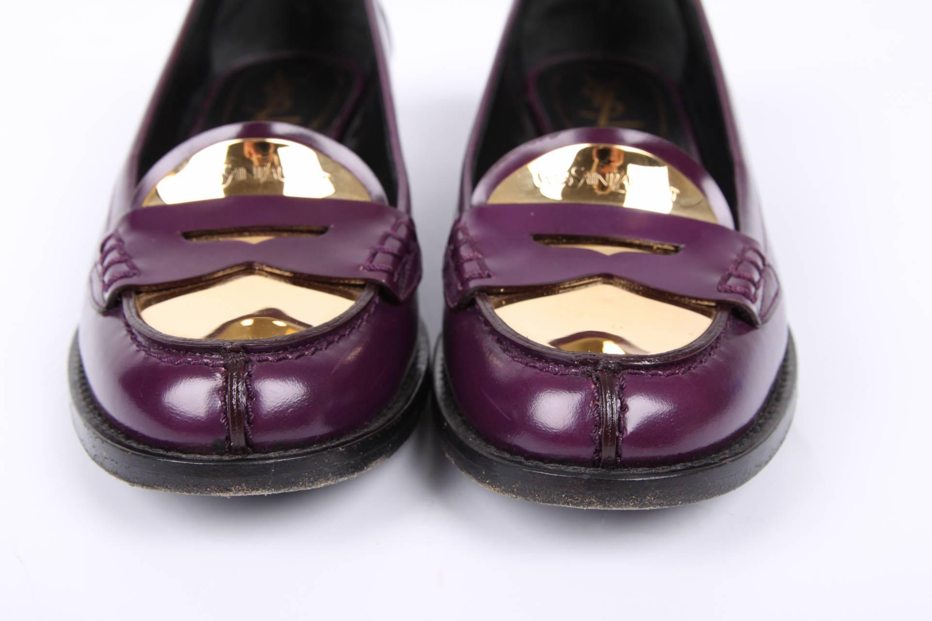 Nice pair of penny loafers by Yves Saint Laurent crafted in purple colored leather with gold-tone detailing at the toe.

The heel measures 2,5 centimeters, outsole made of leather. Fully lined with black leather, a gold-tone YSL Paris logo on the