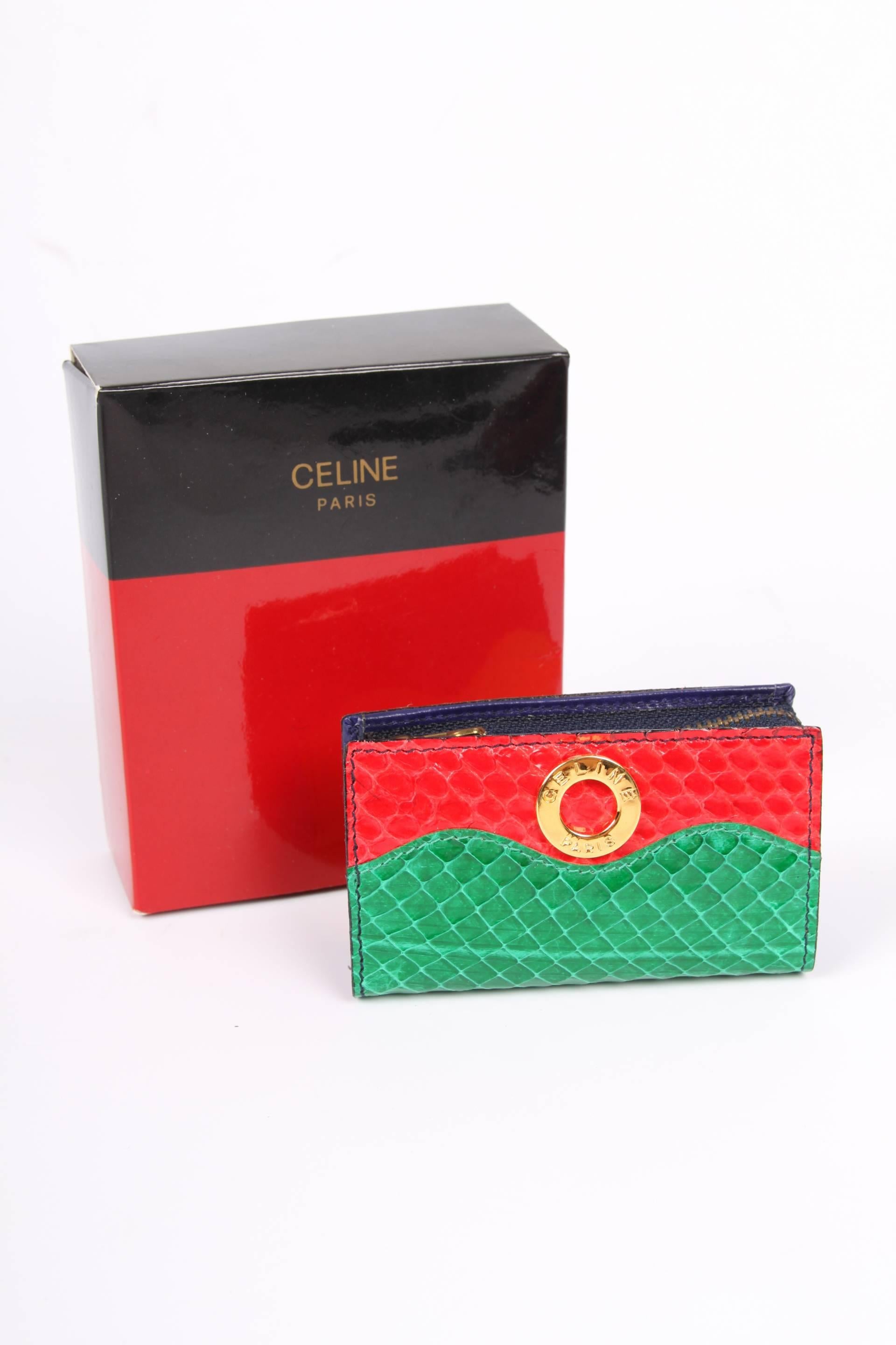 Super cute vintage mini bag by Céline Paris crafted in red, green, blue and yellow python leather.

Zip top closure, a gold-tone metal logo at the front and lining in dark blue leather. It will fit a lipstick, some coins and a tampax. That's about