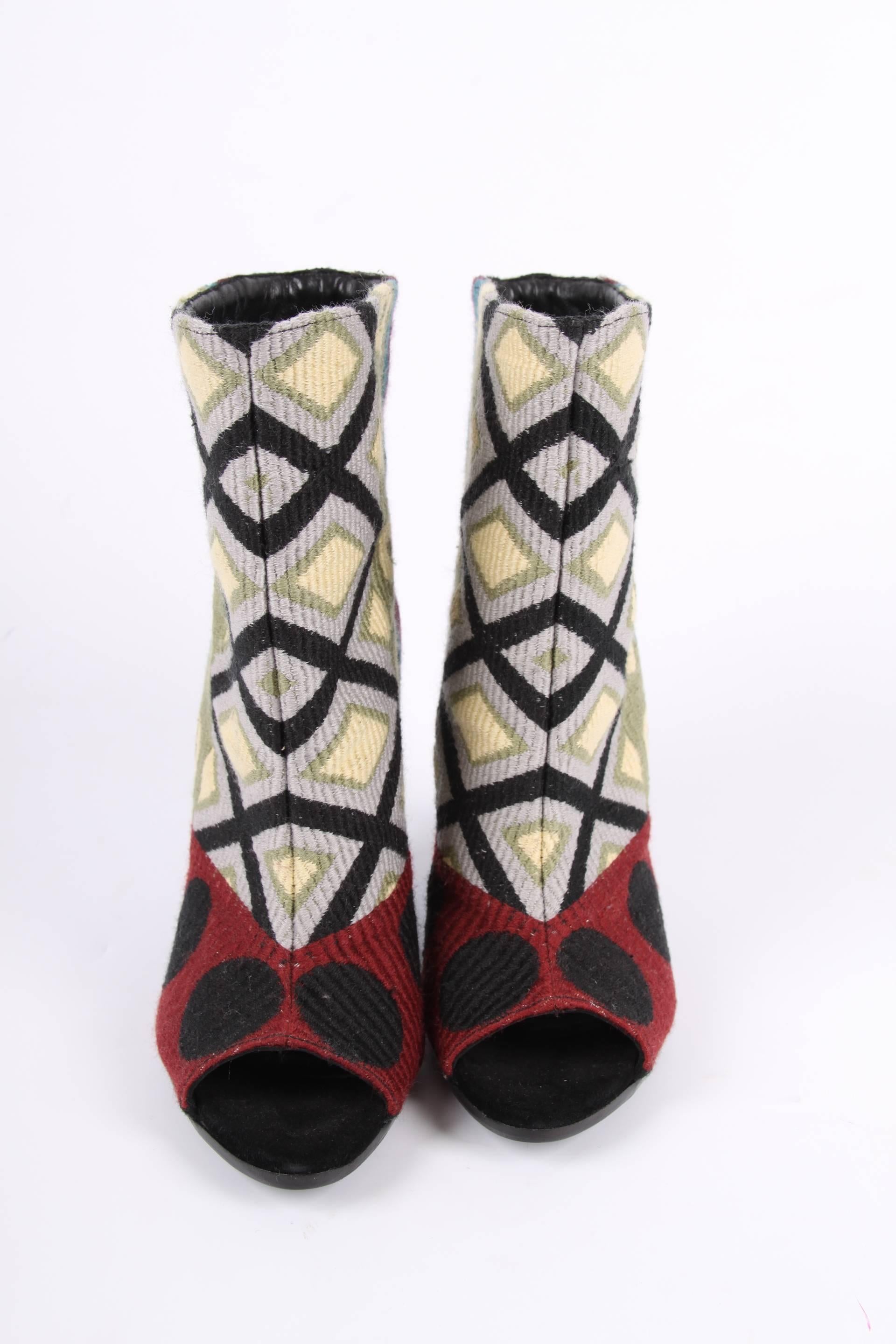 These are the Burberry Virginia Tapestry Booties and they are beautiful!

A peep-toe and a demi-wedge heel that measures 10,5 centimeters, on top a gold-tone plaque with BURBERRY engraved. Multi coloured textile upper with a geometrical dessin in