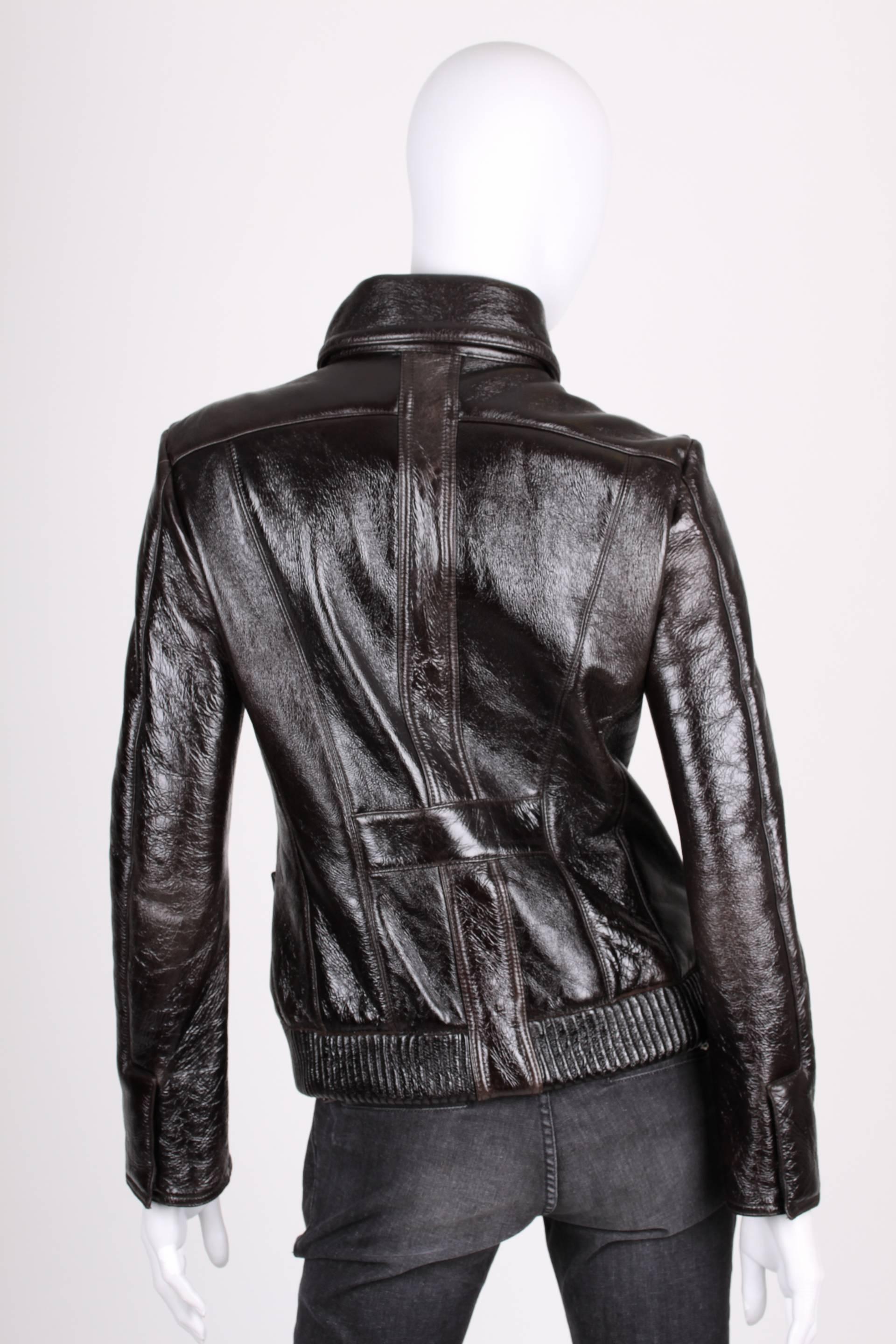 Sturdy jacket by Versace crafted in shiny black leather. We like!!

A round collar with two large silver-tone push buttons with a VJC logo on top. Front closure with a silver-tone zipper, long sleeves, horizontal welt pockets and three zipped