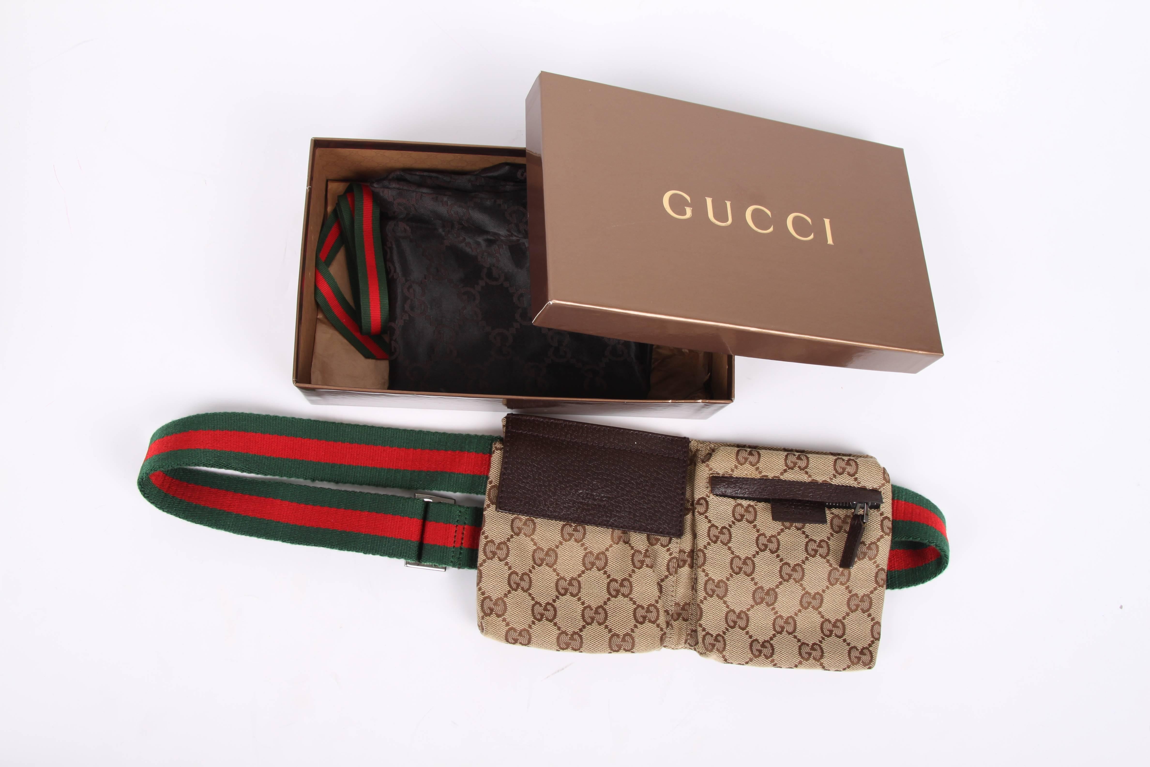 Super cool!! A beige canvas belt bag by Gucci covered with brown Guccissima's.

The adjustable waist belt is crafted of red and green canvas and holds a large shiny silver-tone buckle with a Gucci logo embossed. The bag has a large compartment on