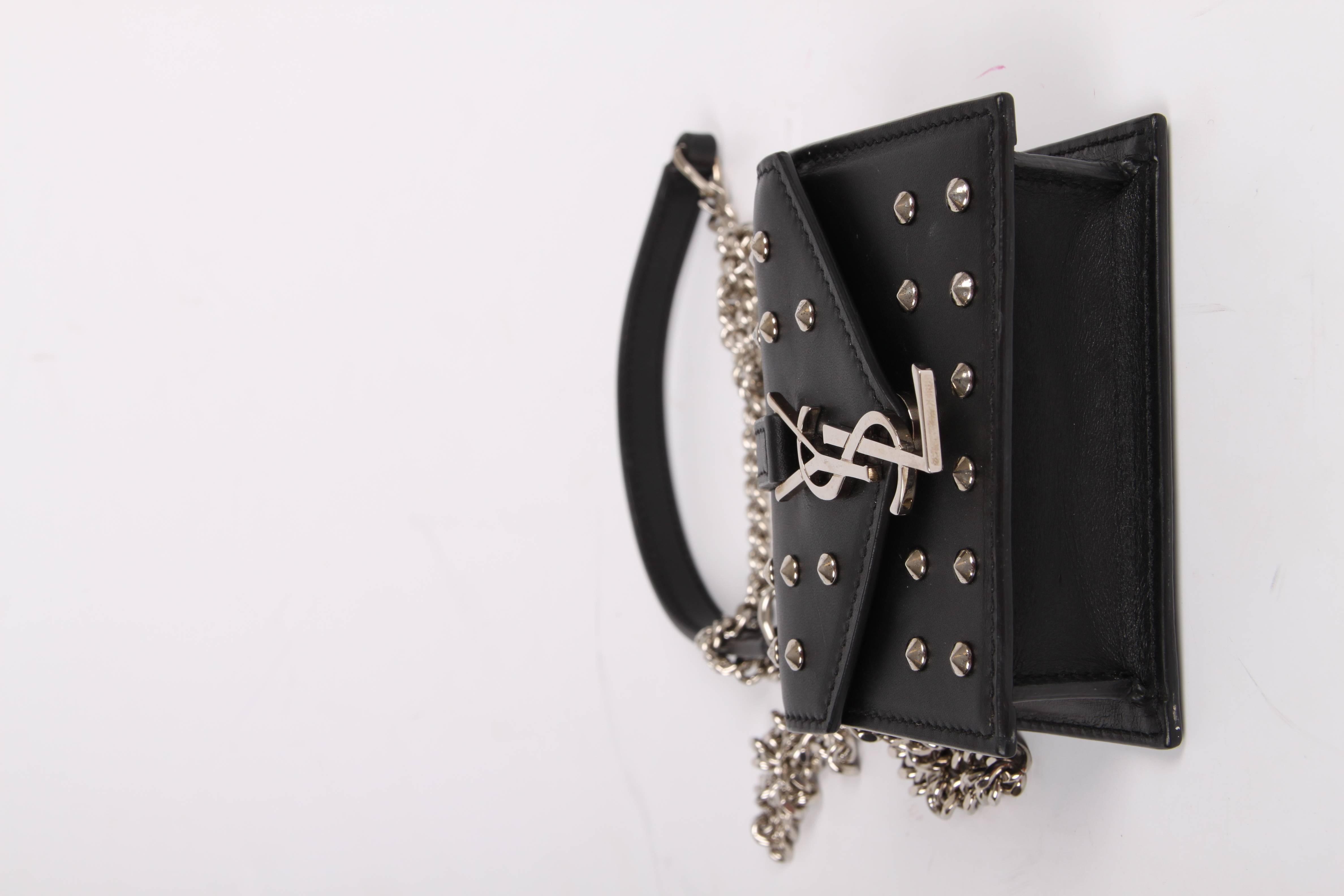 Such a cutie! It is the Mini Candy Bag by Yves Saint Laurent. And it sure is mini!

Covered with silver-tone studs at the front and back. An enveloppe shaped flap with a silver-tone YSL closure, a long chain strap with a leather piece. Perfect for