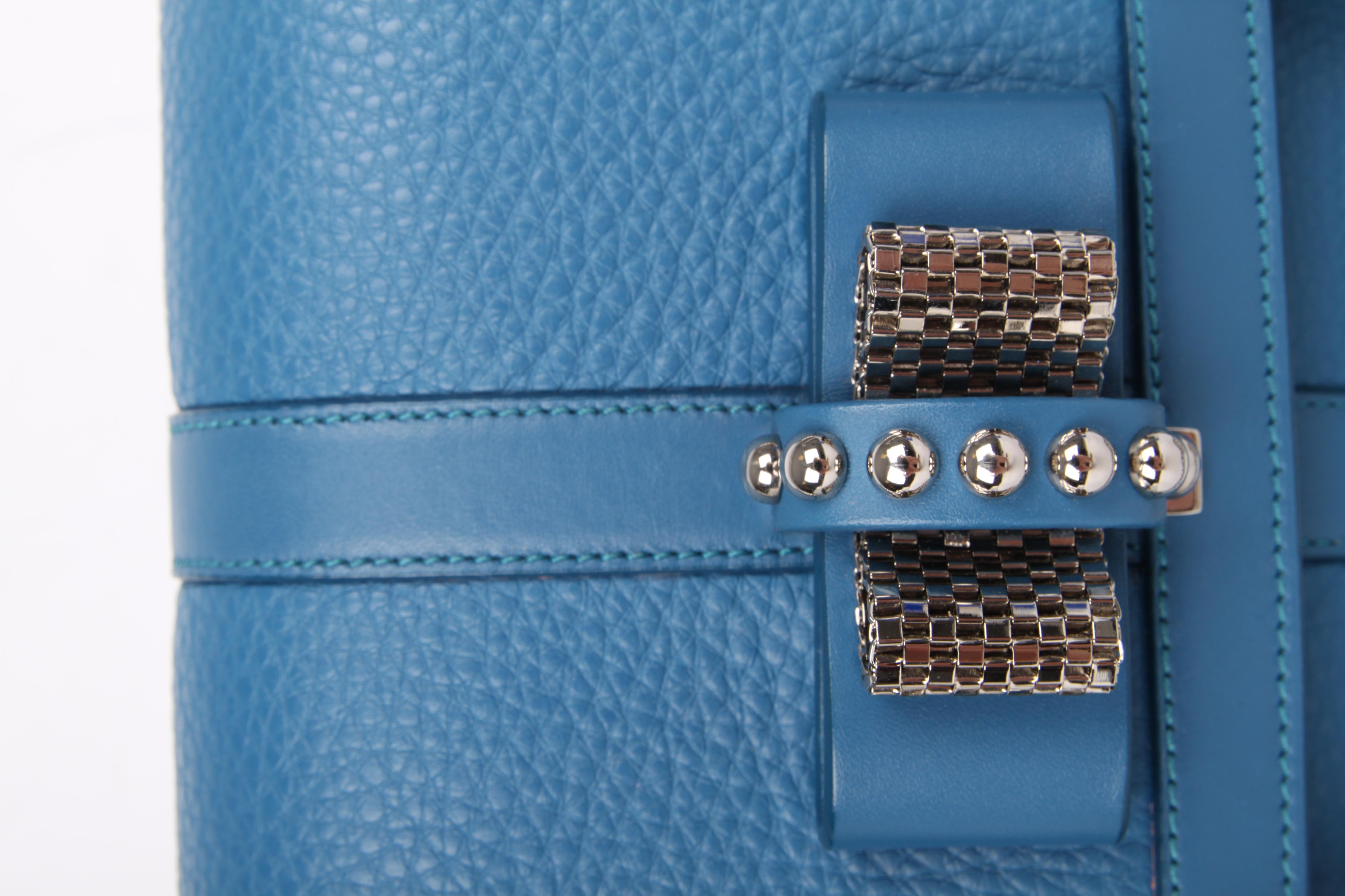 This is the Sweet Charity shoulderbag by Louboutin, adorable!

Crafted from blue grained leather with silver-tone hardware. Front closure with a sweet bow embellished with studs. The chain can be worn single or double.

Of course the lining of this