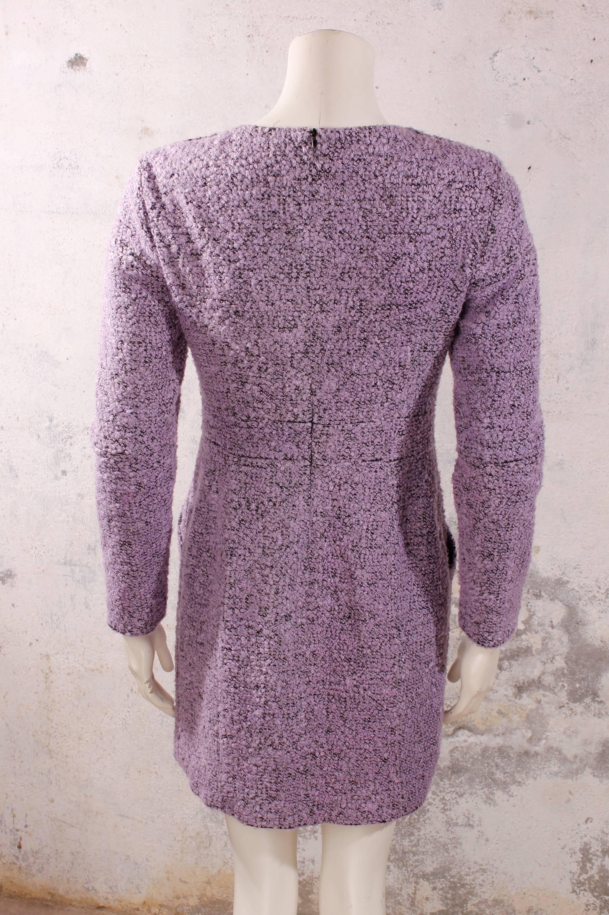 Purple / black boucle long-sleeved dress with 100% silk lining. Beautiful dress with decorative Gripox knots on the shoulders, two on both sides. Side pockets on the front that close with the same Gripox buttons. 
Dress made of 97% wool and 3%