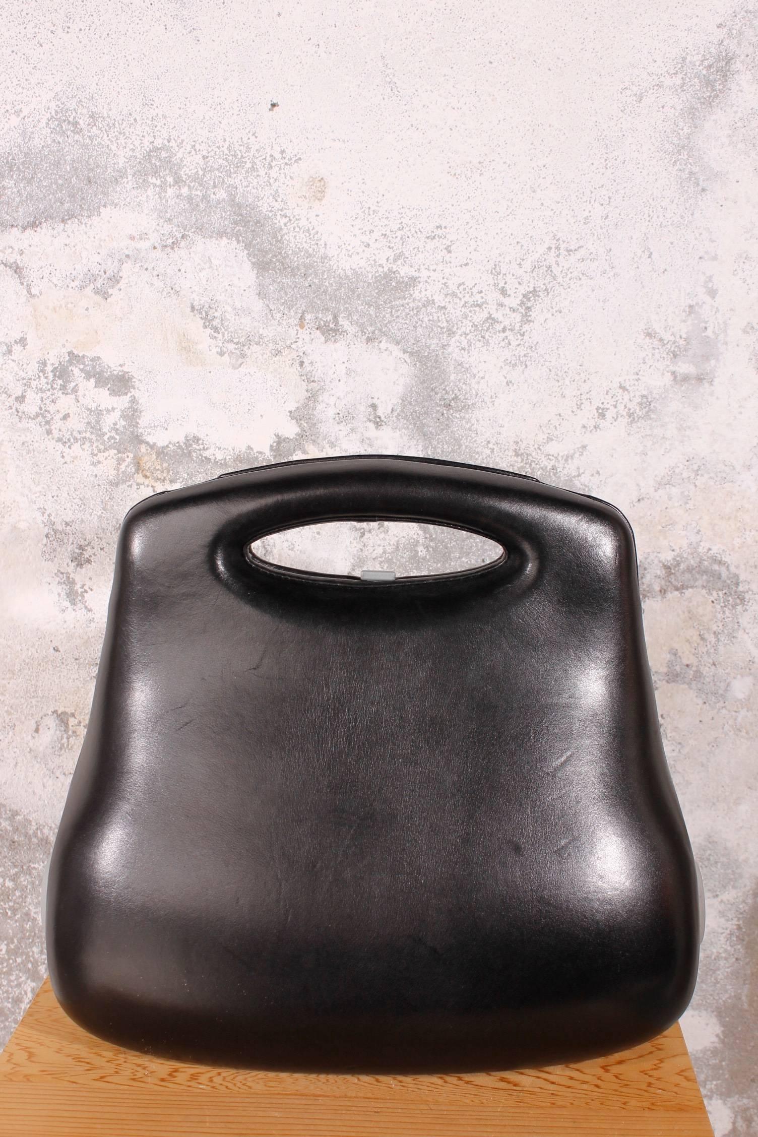 Karl Lagerfeld created this bag to celebrate the 21st century.The inside of the bag resembles a woman's corset. Like other modern couturiers designing for the new millennium, he sought to redefine the shape of a woman's handbag. 