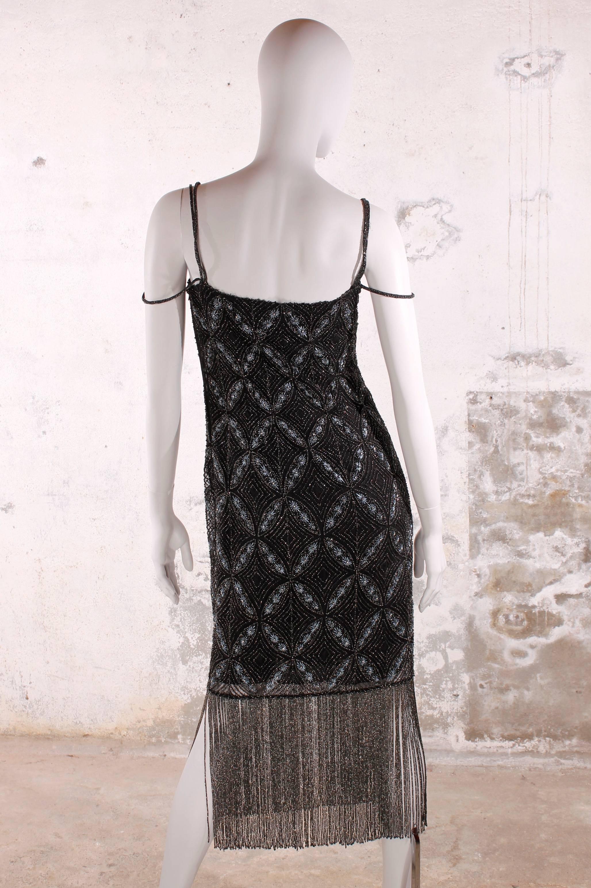 Stunning Christian Dior evening dress with a marvellous pattern, fully covered with beads and embroidery.

Three straps on each shoulder, one of them is supposed to hang down from the shoulder. As to be seen on the picture. The upper layer of the