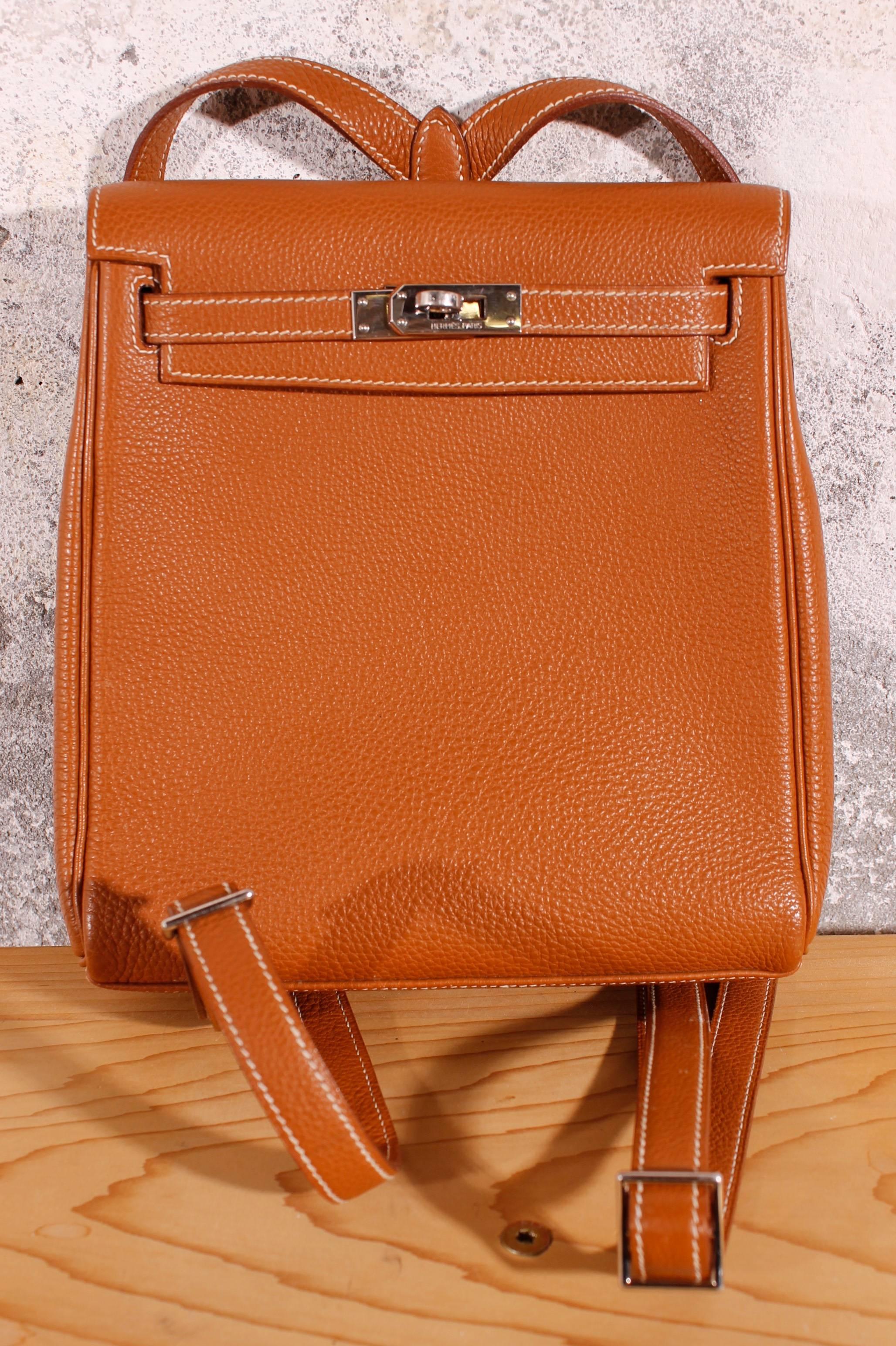 This Hermès backpack is a fun and functional spin off of the classic Kelly bag. The exterior is brown togo leather, which is slightly grained. The bag features a turnlock closure and two adjustable shoulder-straps. 
Interior is matching brown
