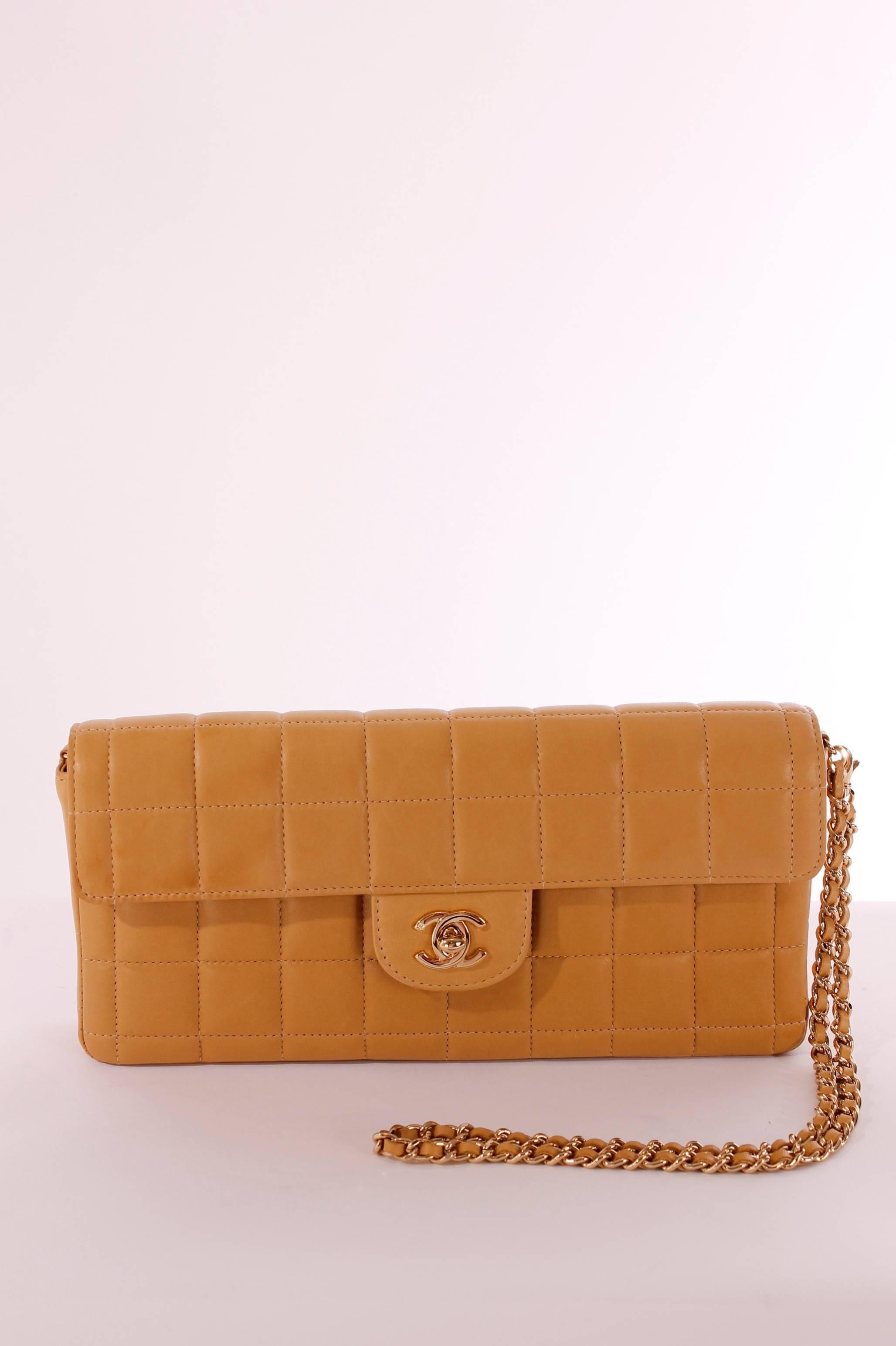 2003 Chanel East West Baguette Flap Clutch Bag in camel coloured lambskin leather, adorable!

This bag was considered the little sister of the Chanel Classic Flap Bag. The style is quite similar, and we love it!

Very rare, because this model