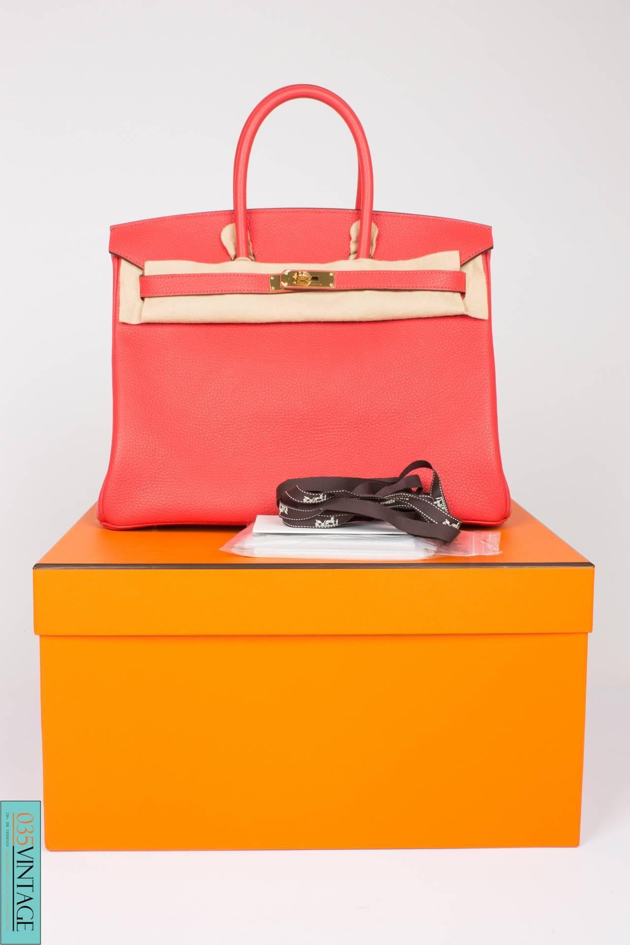 Brand new is this Hermès Birkin Bag 35 in Clemence leather with goldtone hardware, this color is named Rouge Pivoine. A kind of coral red at its very best!

Front toggle closure, clochette with lock and two keys, and double rolled handles. The
