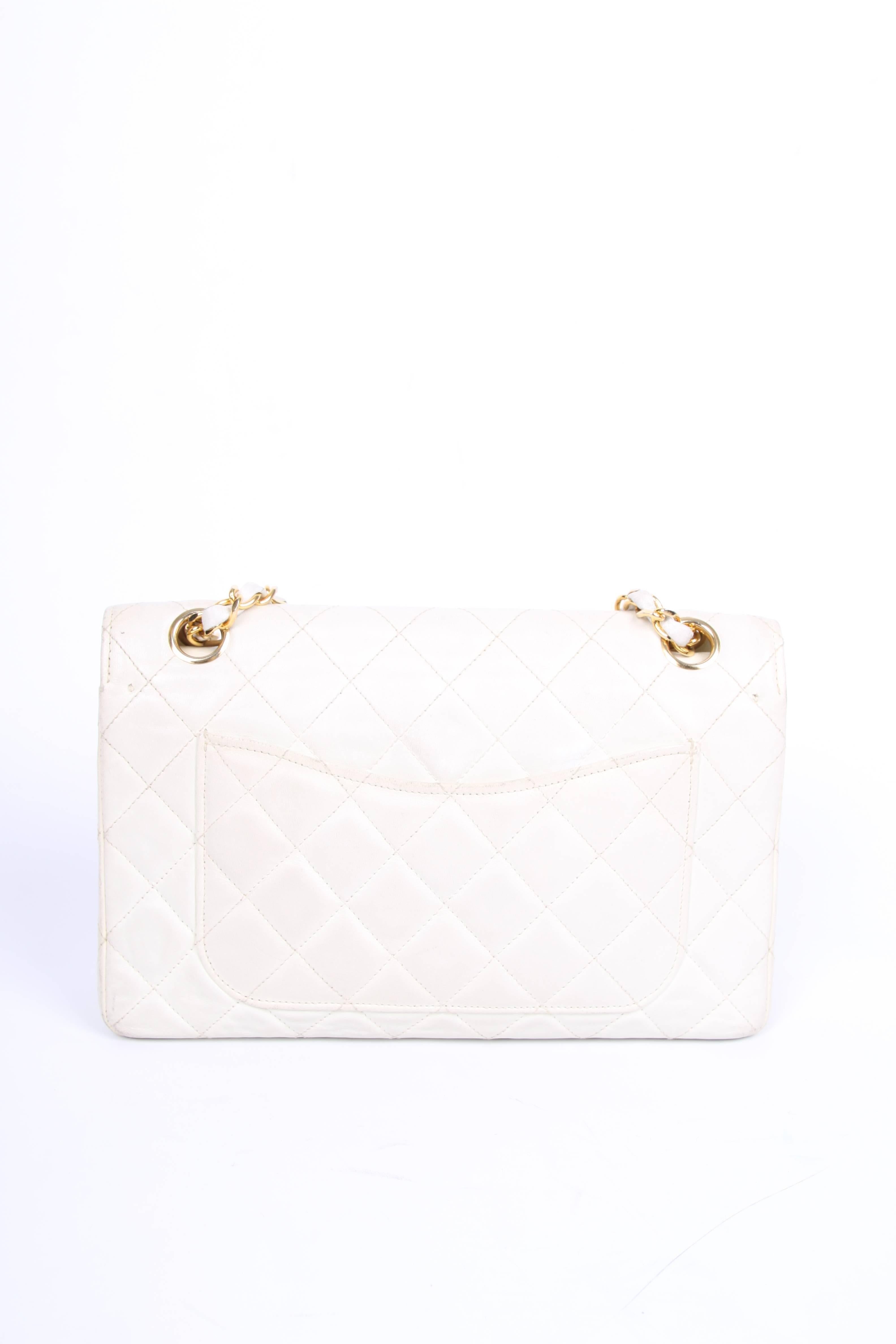 This one is really old, rare and a collector's item!

A vintage Chanel Double Flap Bag that's about 33 years of age. It is one of the first bags with a CC turnlock closure designed by Karl Lagerfeld in 1983. Very rare!

This ivory white bag is fully