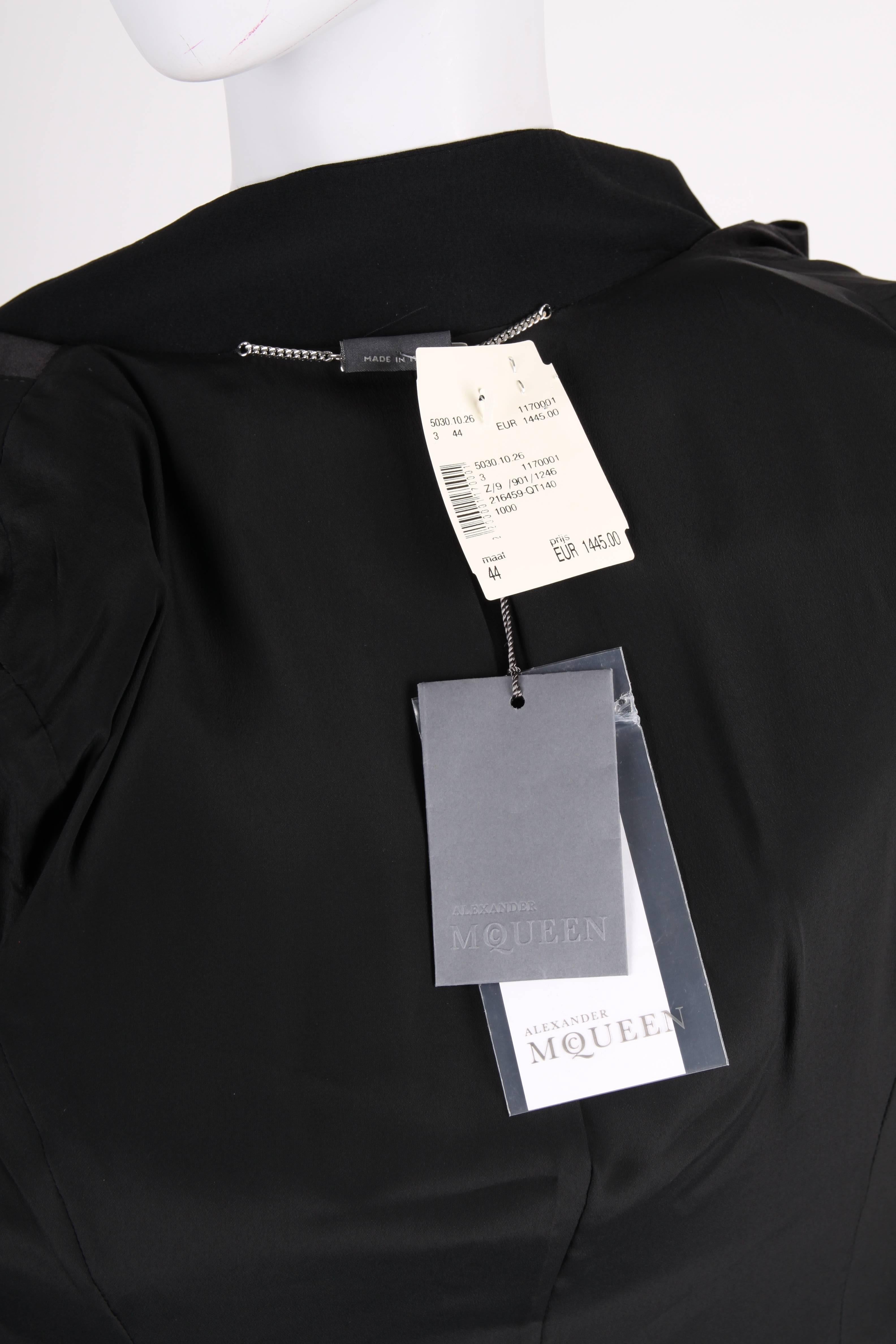 We have a winner!! When you don't know what to wear these holidays; this is it!!

A stunning dress by Alexander McQueen based on the design of a tuxedo. Straight shoulders with rather large padding, long sleeves with three buttons at the end,
