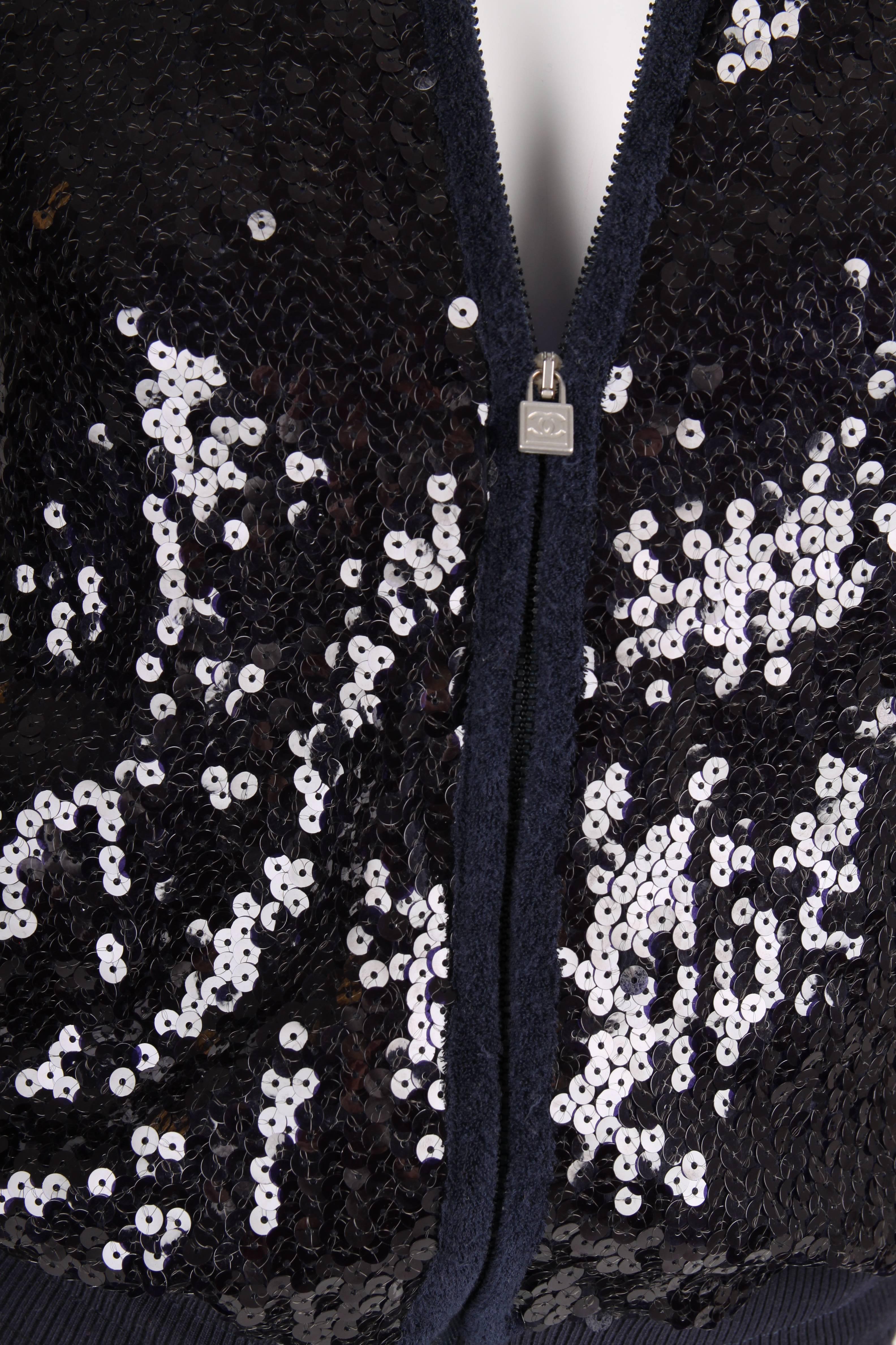 A dark blue sequin jacket from the Sports Line of Chanel, 2008 Cruise Collection. Fancy!!

Front and back are covered with sequins, terry cloth detailing on the sleeves and the area around the zipped pockets. A drawstring at the collar, in the waist