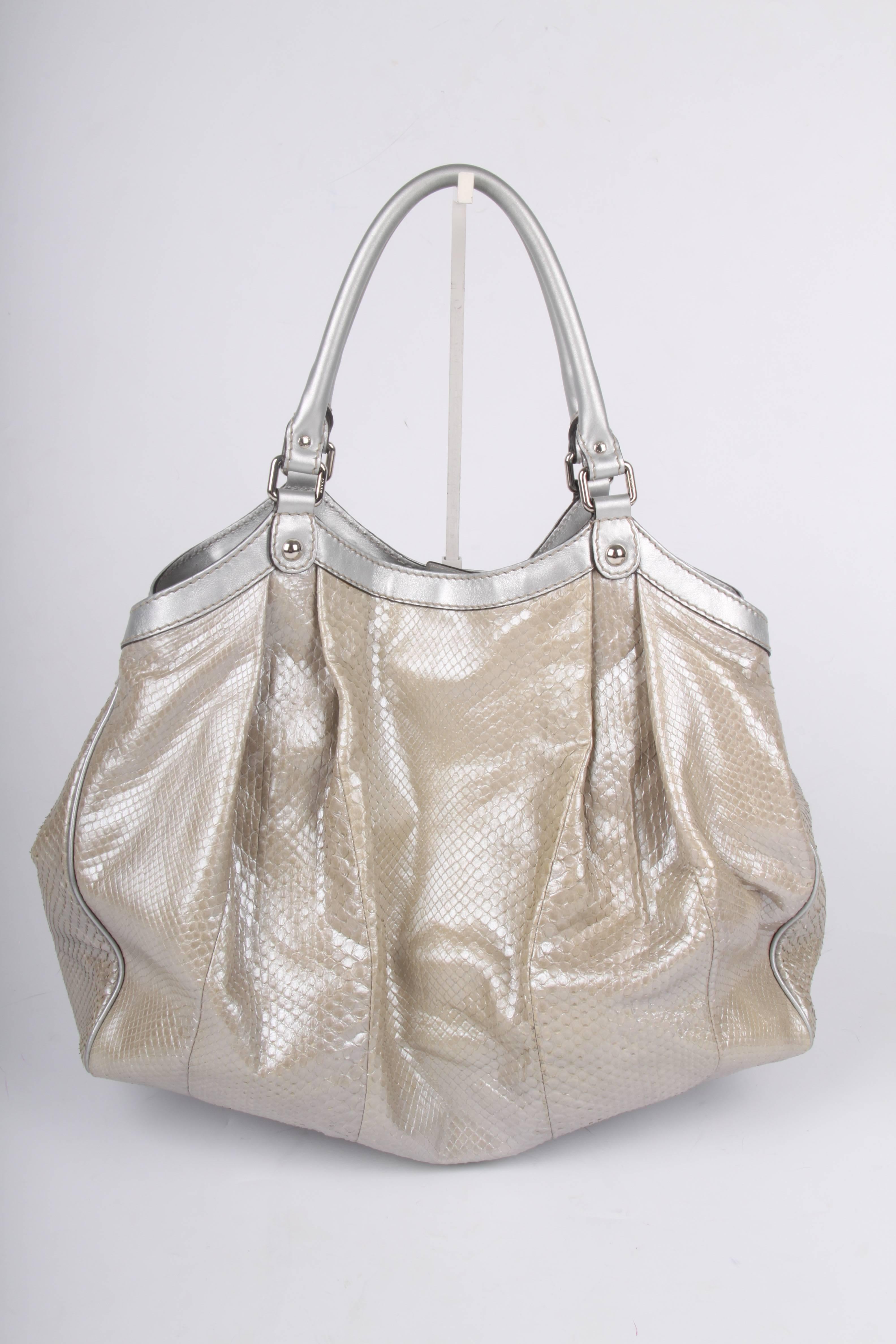 antastic Gucci Sukey Tote Bag crafted from silver-tone python leather.

Large sized bag in a sunny silver-tone color; we would take it with us to the beach right away. It will certainly fit al your belongings, it is a really huge bag.

Fully made of