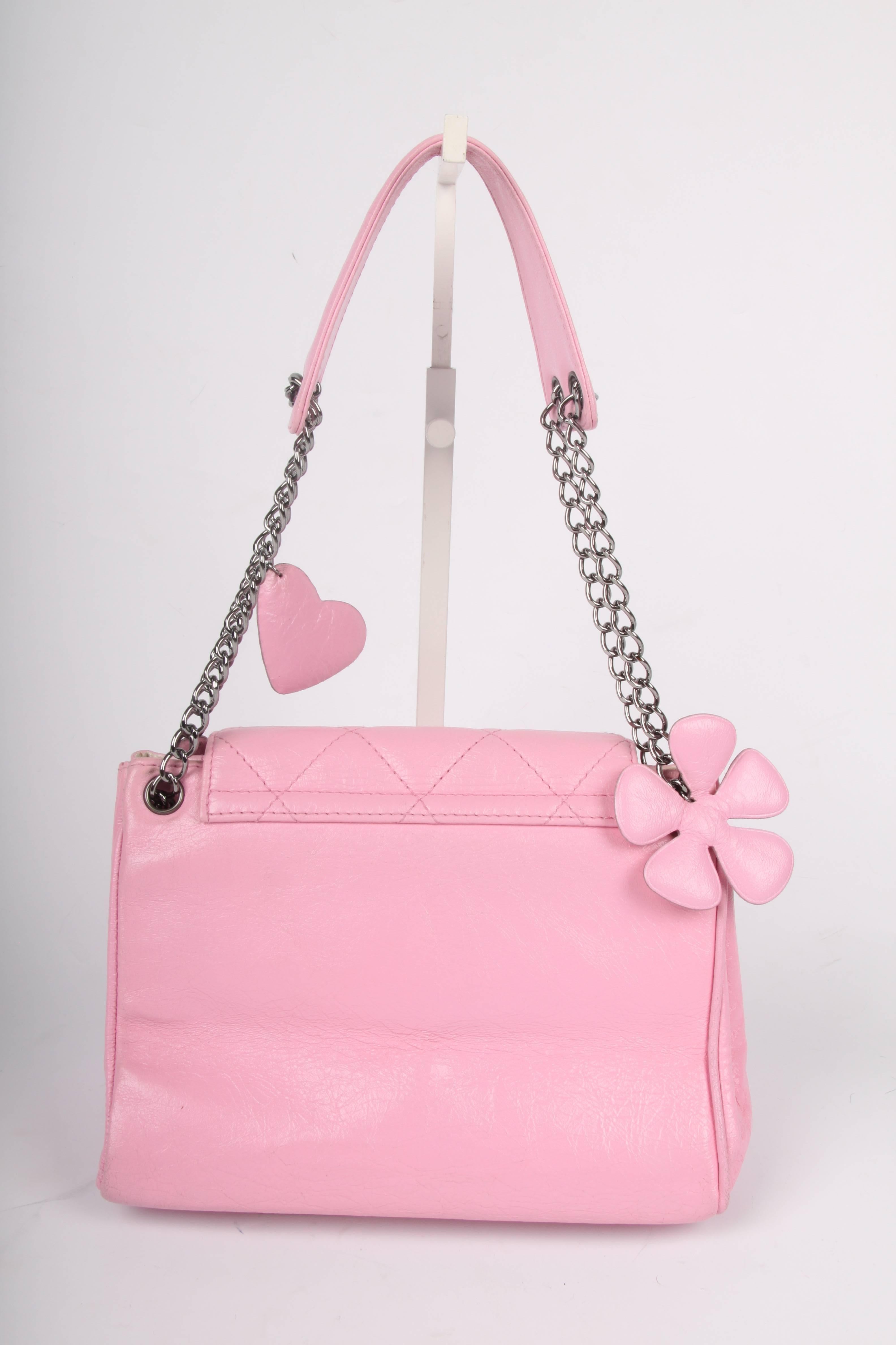 Sooo sweet! Chanel bag with leather hearts and a flower dangle attached to the chain...

Front closure with a large silver-tone lock embossed with CC and CHANEL. The pink leather has a 'crinkled' look and the flap and front are both quilted.

Lining