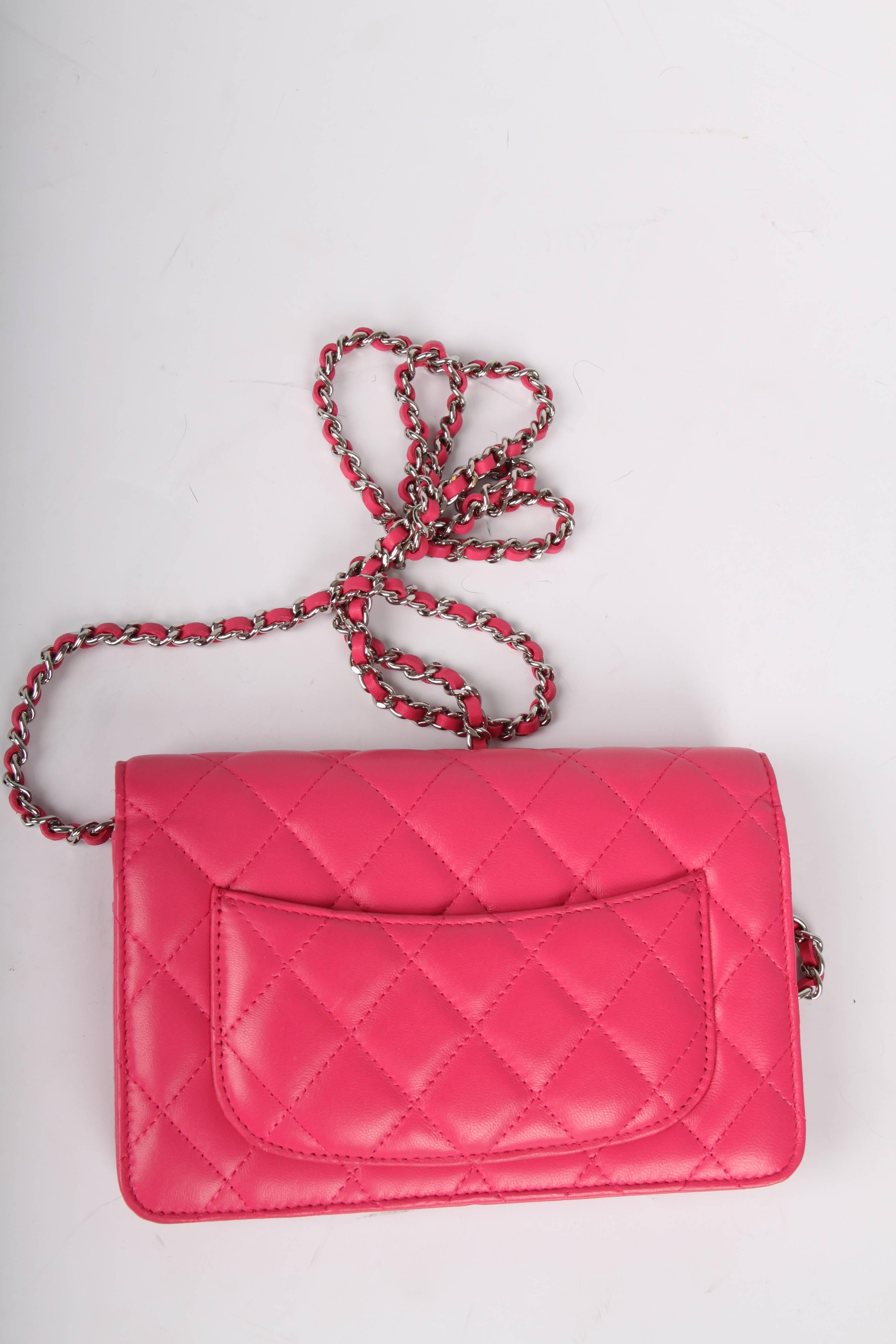 Highly desirable Chanel bag; it is the Wallet on Chain! Wearable on the shoulder and also cross body, of course.

Pink quilted lambskin leather and silver hardware, a small silver-tone metal interlocking CC logo on the flap. The chain has pink