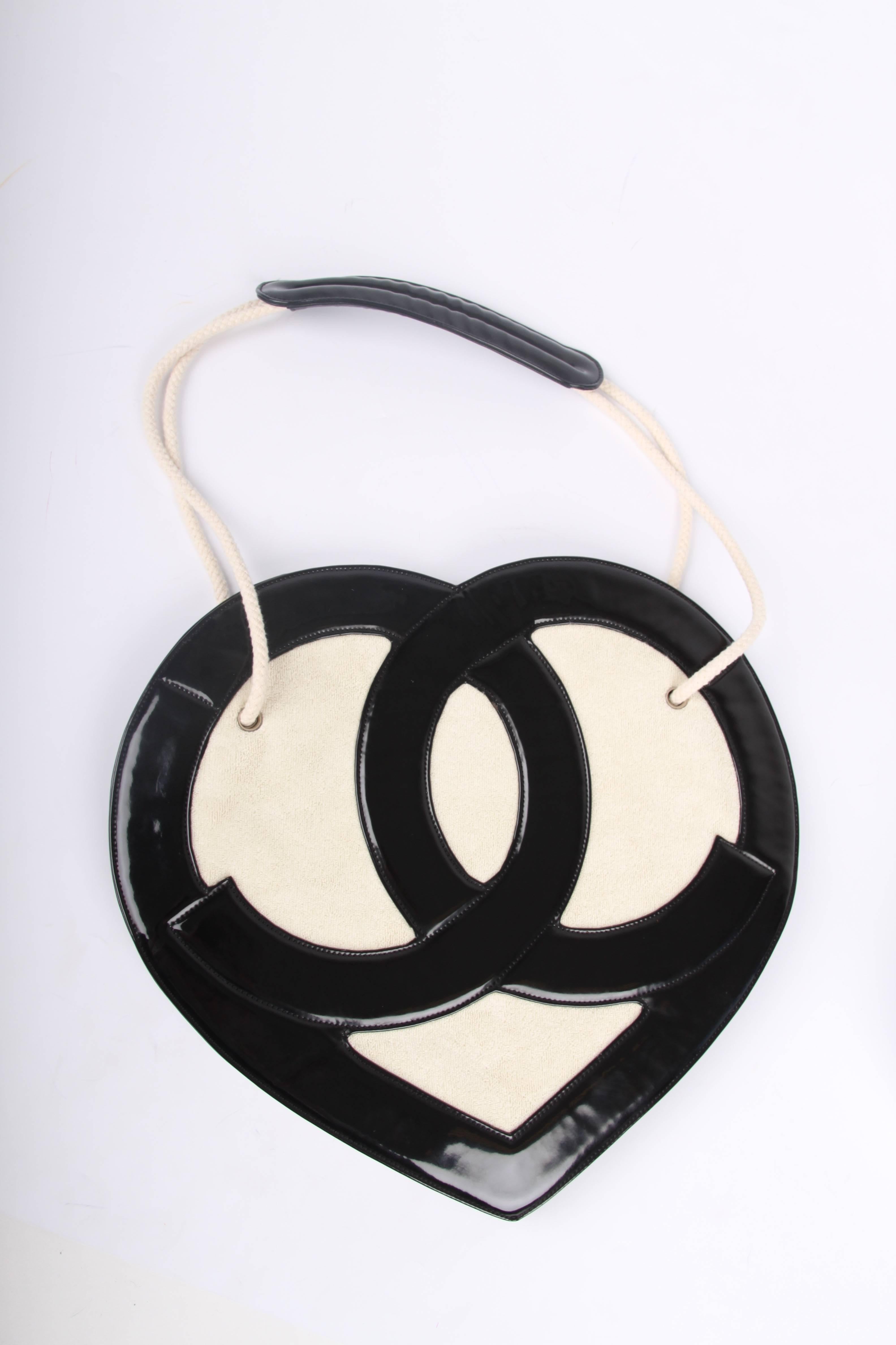 This bag is from the Chanel Cruise Collection of 2009, a true runway piece; the Chanel Heart Shaped Bag!

Made of black patent leather and white terry cloth with a super large CC logo at the front and back in a heart shape. How adorable! The handles