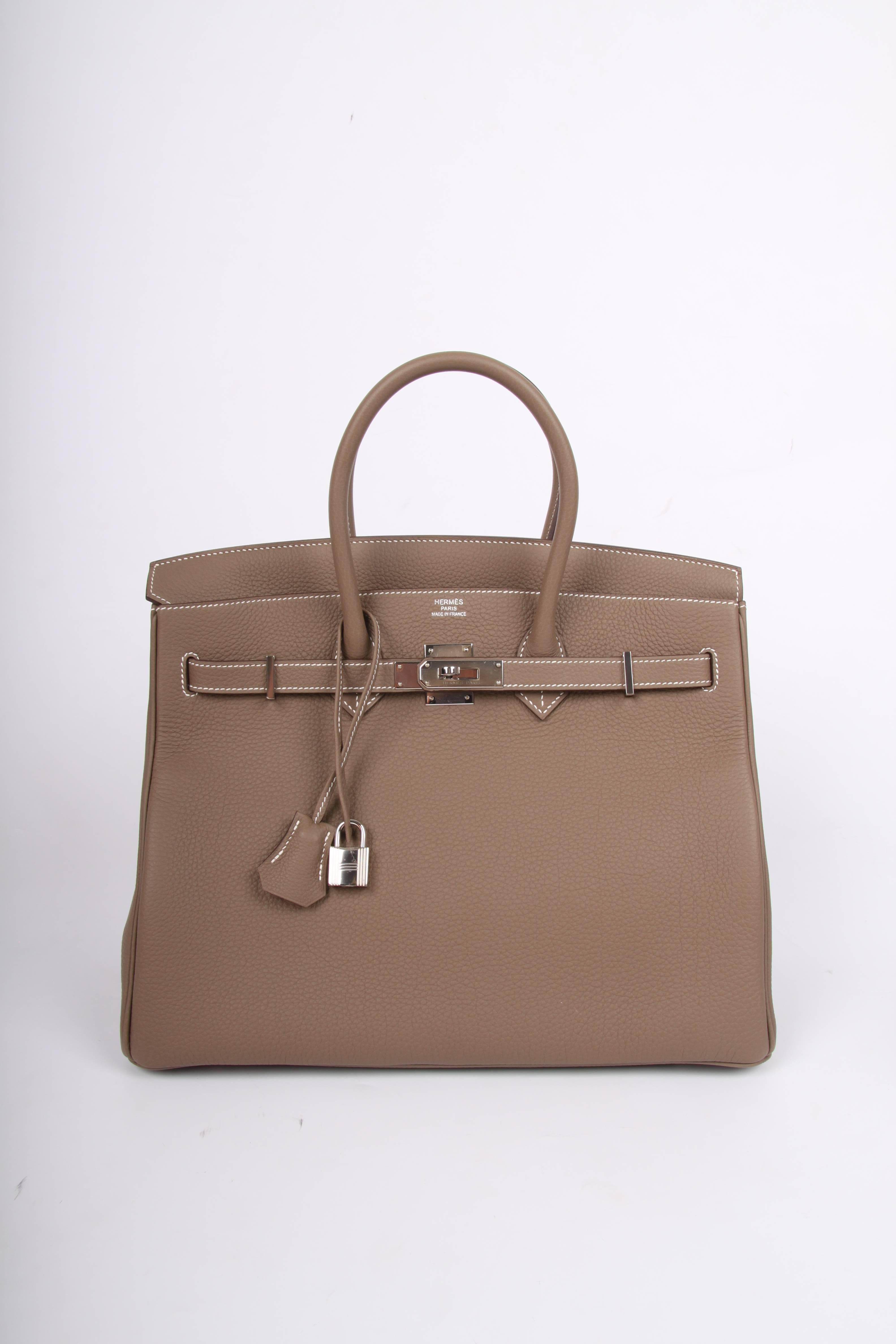 Hermès Birkin Bag 35 in Togo leather with silvertone hardware, this color is named Étoupe. A shade of taupe at its very best!

Front toggle closure, clochette with lock and two keys, and double rolled handles. The Togo leather has a visible grain,