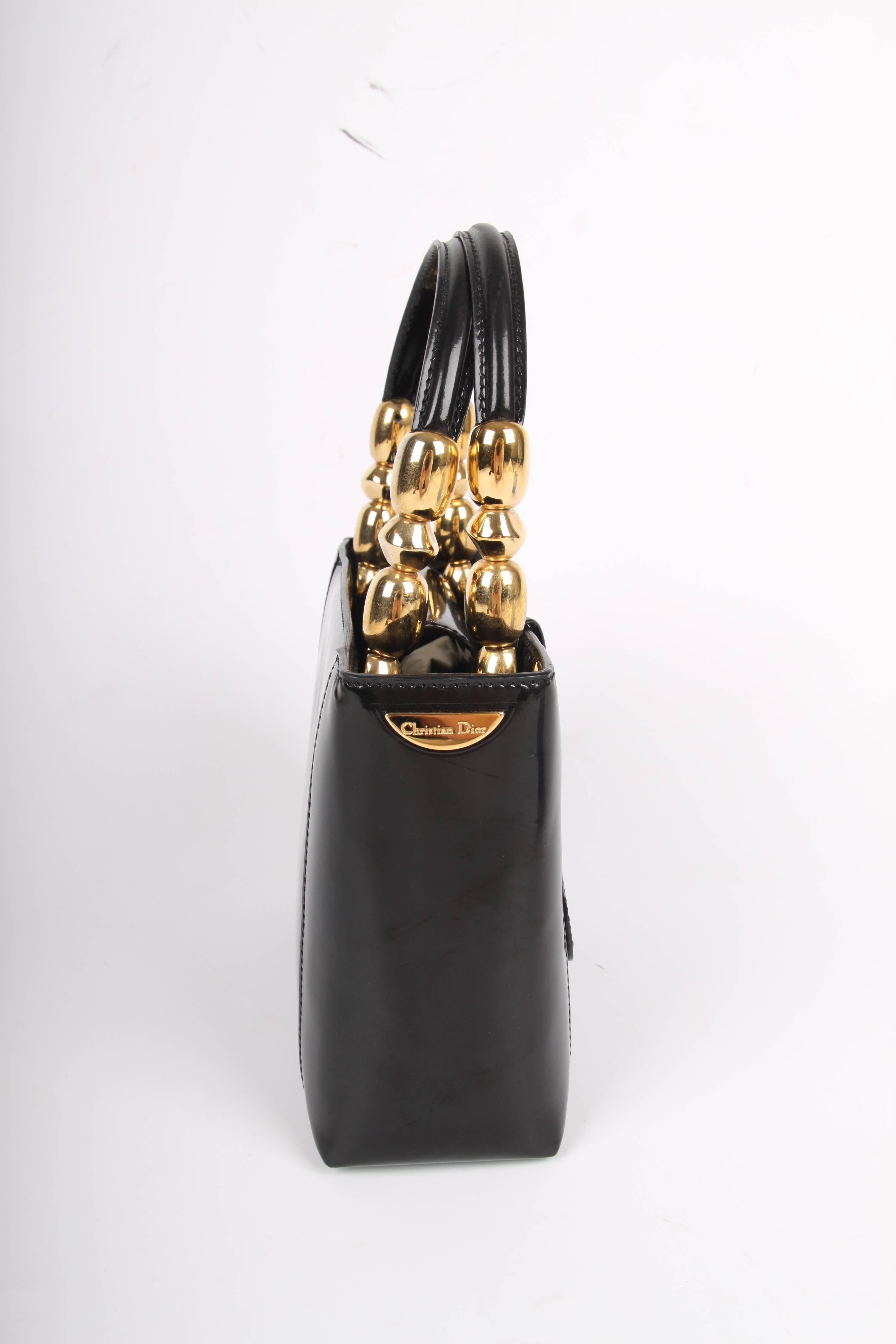 
Adorable! The famous Lady Dior Bag in black patent leather, this piece is vintage! 

Fully crafted from black patent leather with gold-tone detailing on the short handles, on the left side a gold-tone Christian Dior logo and a leather tag with