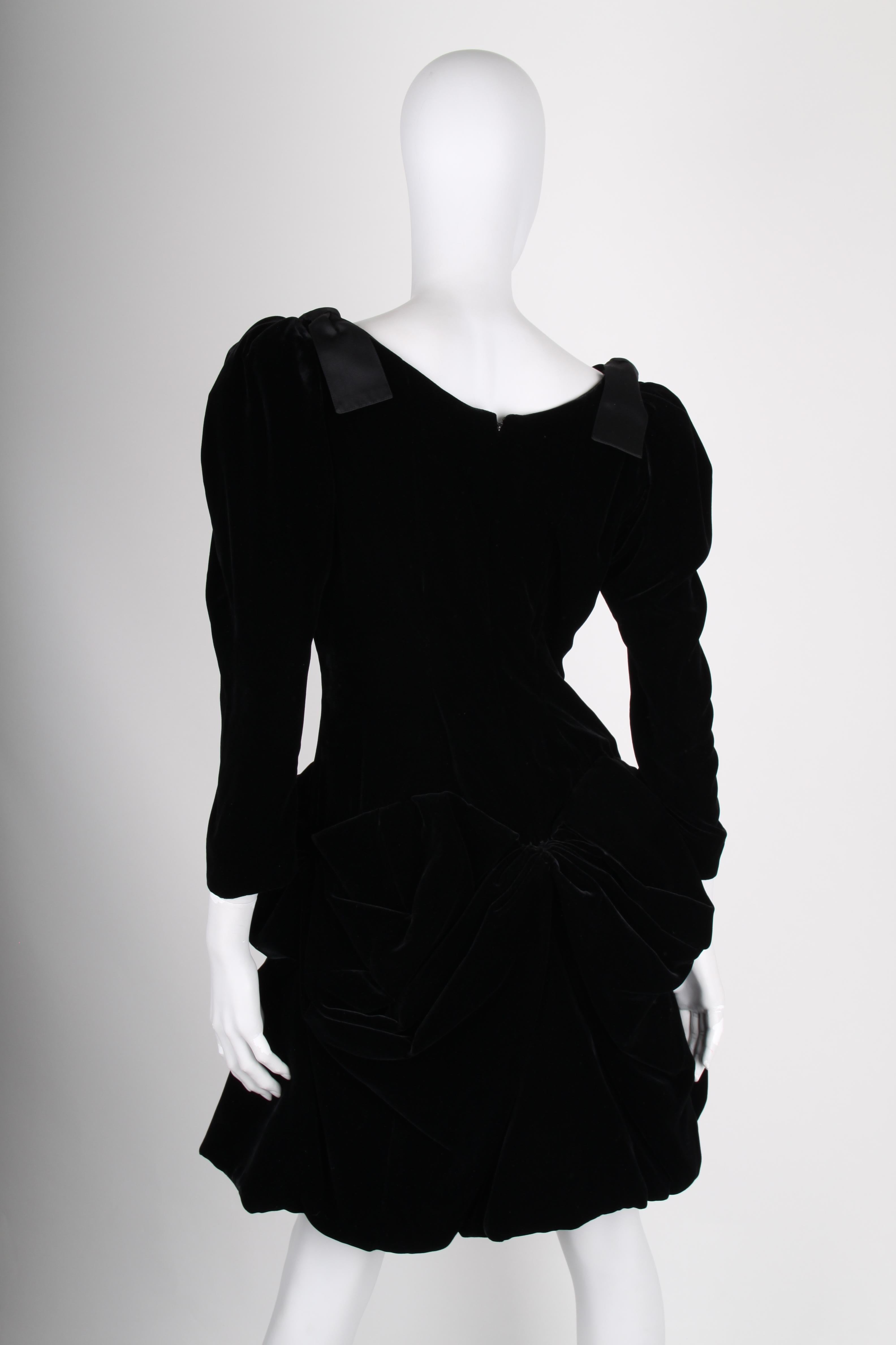 This vintage dress by Yves Saint Laurent is soooo cool!

Made of black velvet; a deep V-neck, long sleeves, bows on the shoulders and a super wide skirt. Fully lined, the skirt has a red/pink petticoat, Very neat!

Back closure wit a zipper, the