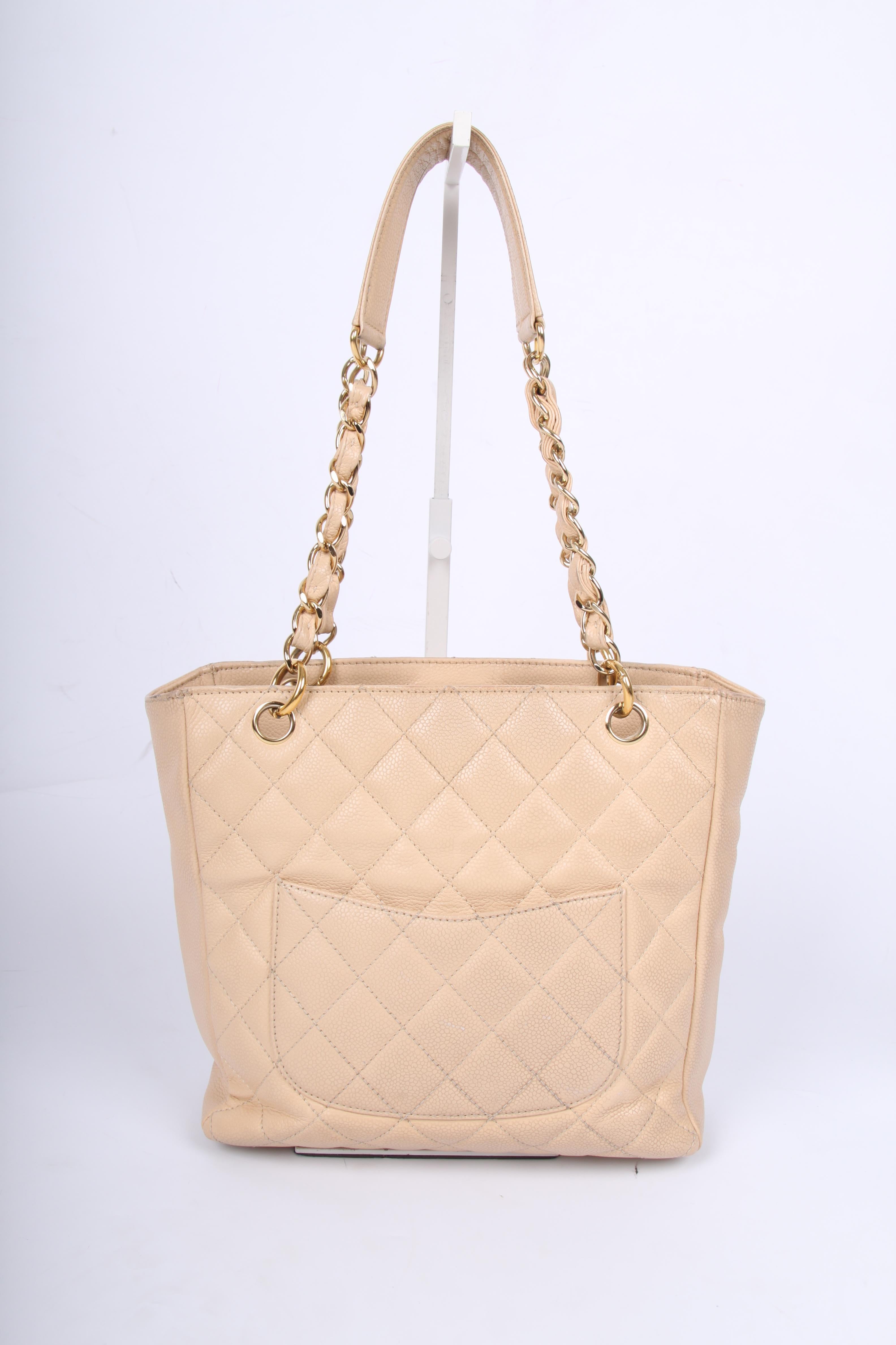 We don't see this classic bag by Chanel very often, but it is a true beauty! Timeless, this piece was once designed by Coco and still in fashion.

A beige mini shopper with golden hardware in caviar leather. Large interlocking CC at the front of