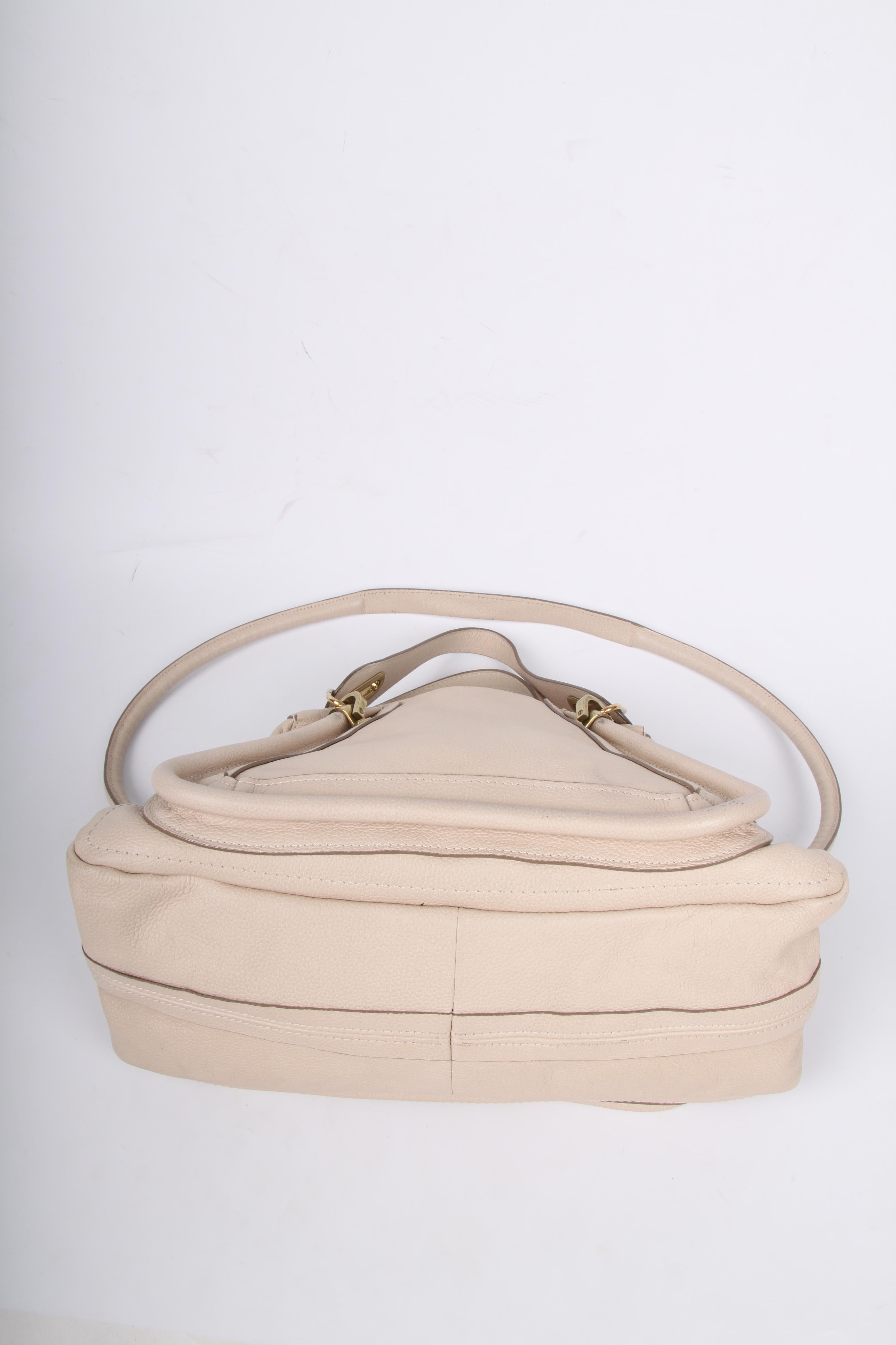 Chloé Paraty Bag in Husky White leather, this is certainly not a bright white tone.

Rather large size, gold-tone hardware, zip top closure. Two handles and a long shoulder strap.

grained calfskin leather
gold-tone hardware
side twist-lock