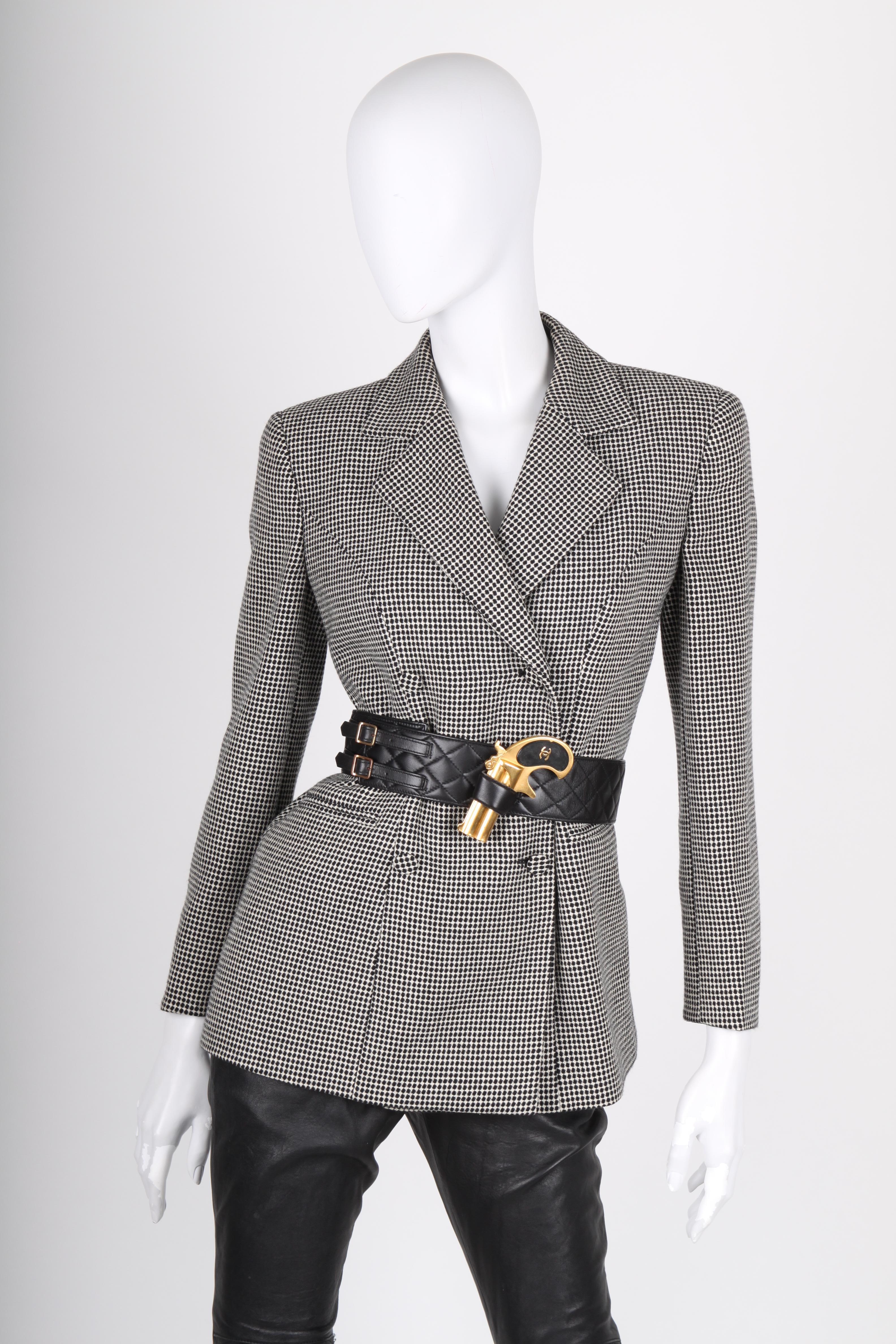 This fantastic vintage belt by Chanel is about to blow you away!

Rare and unique belt crafted from quilted black leather. The belt has a gun holster with a gold-tone gun in it. Black accents on the handle of the gun, of course embellished with the