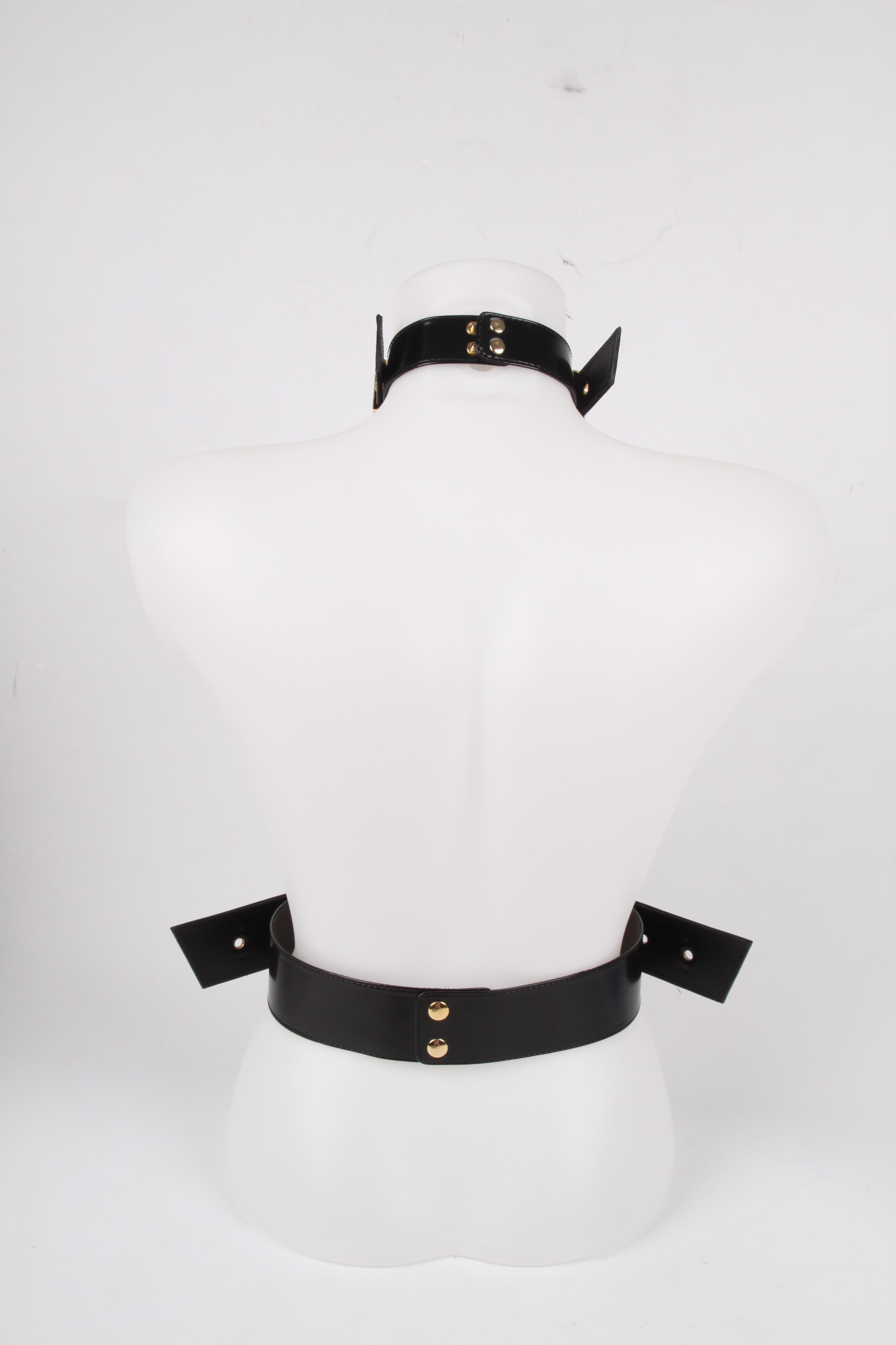Fantastic fashion statement by Giuseppe Zanotti; a black leather body belt with gold-tone hardware. The wide belt is worn in the waist and has snap button closure on the back. The vertical belt and necklace belt are both adjustable with the large