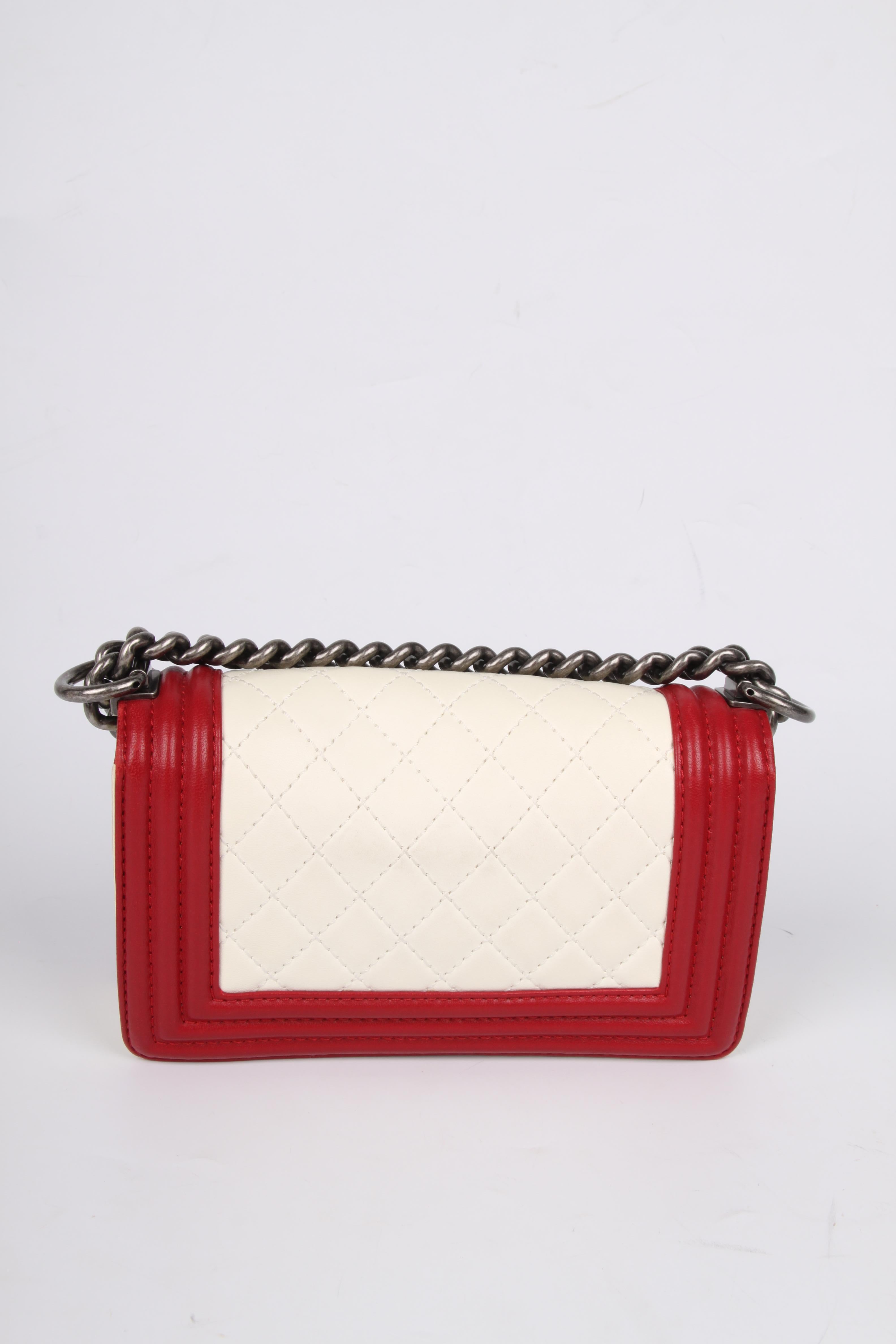 
The iconic CHANEL Boy Bag with a modern look, this one is a mini!

This red/white bag is from 2012/2013, in 2011 Karl Lagerfeld introduced the signature lock of this bag. An unique lock, you have to push it on both sides to open it. Karl says Coco