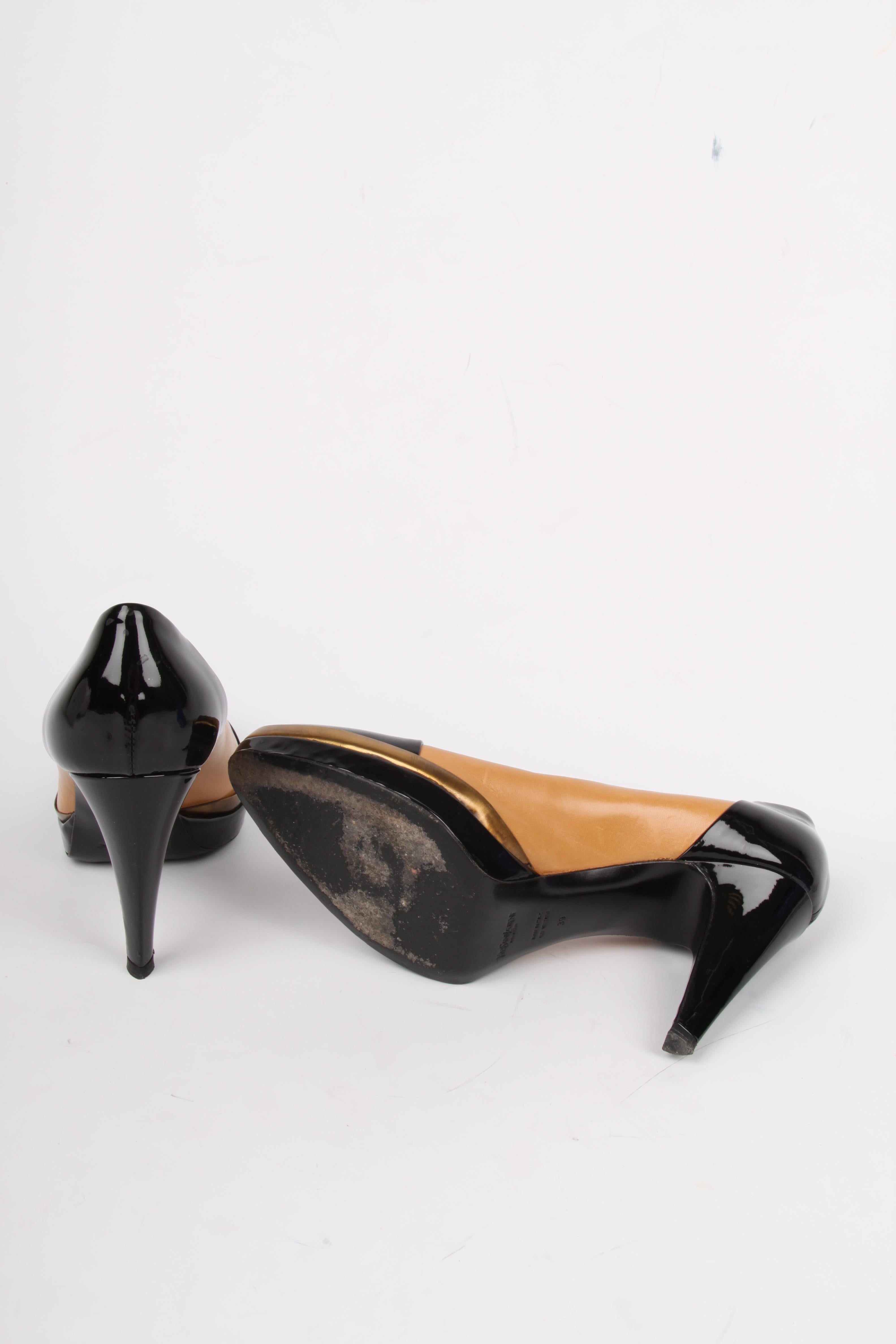 YSL Yves Saint Laurent made this perfect pair of heels!

A cap toe in black patent leather, just like the heel. The heel measures 10 centimters, the platform is 1,5 centimeters high. Right above the platform a small piece of copper-tone metal is