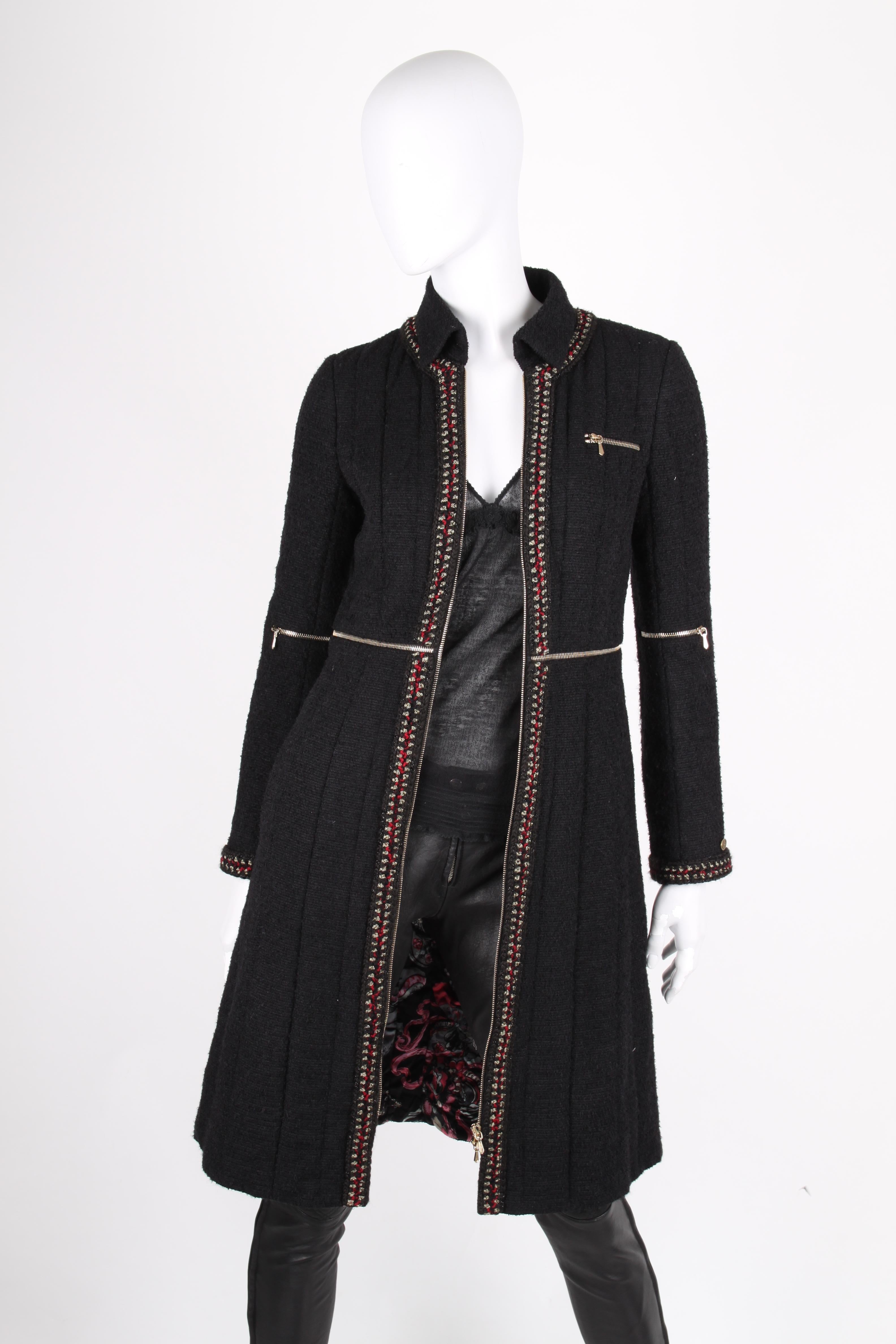 Very special Chanel coat from the pre-fall collection of 2010

A small round collar, long sleeves and zip closure at the front. A small zipped pocket on the left chest and welt pockets on hip height. Embellished with several silver-tone zippers; in