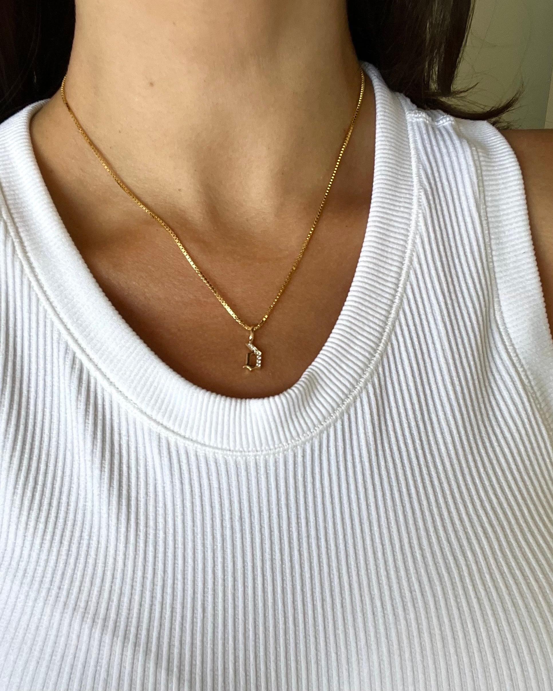 LIMITED TIME SUMMER SALE

Elegant in form and endlessly versatile, this solid 14k gold box chain is finished with our signature hand-pavé double-sided diamond clasp and gothic style diamond initial pendant. Chain and one initial of your choice is